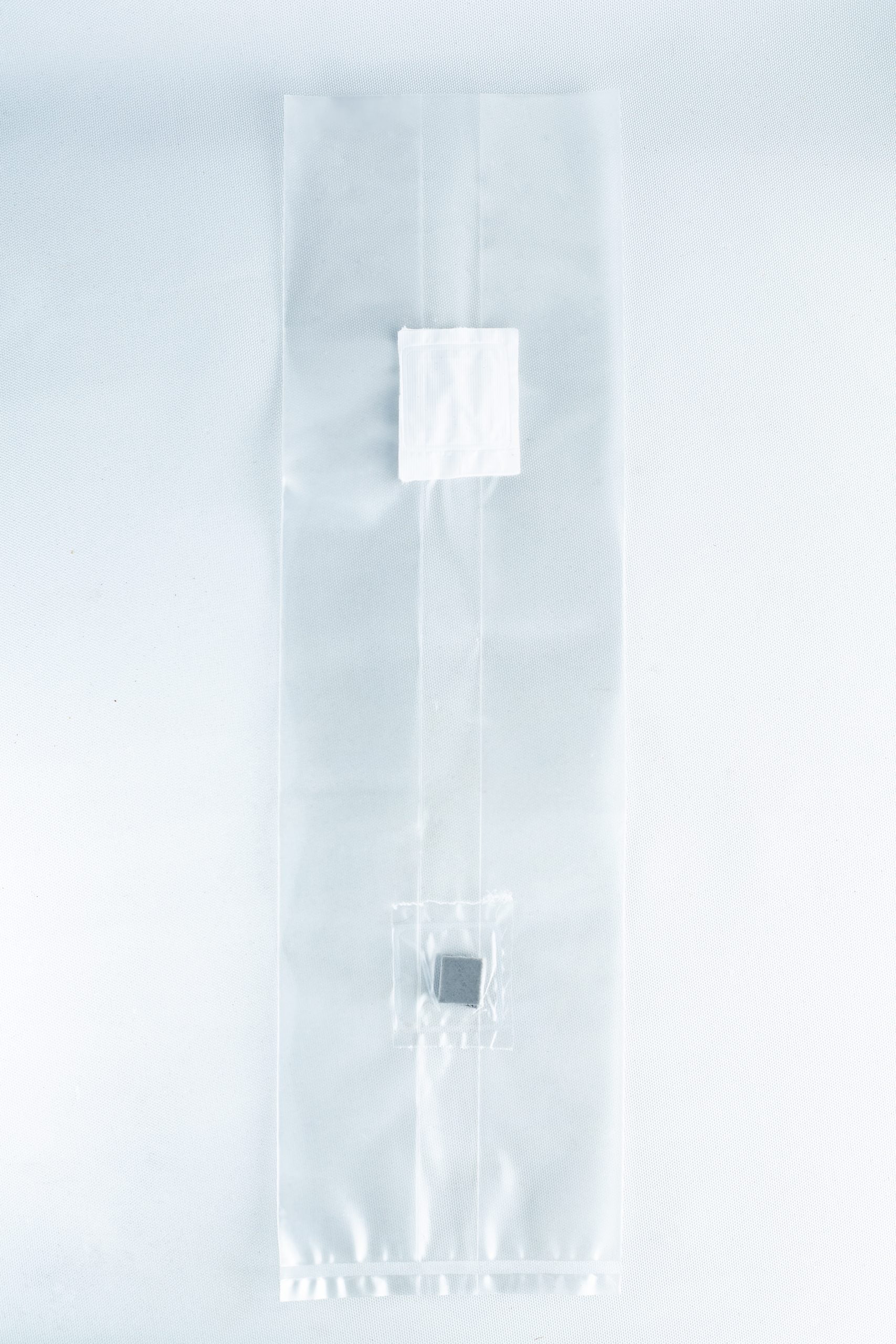 Unicorn Mushroom Grow Bags for spawn and substrate 6 A clear plastic Mushroom Grow Bag Unicorn for spawn and substrate, featuring two small compartments with items inside, is displayed on a white background.