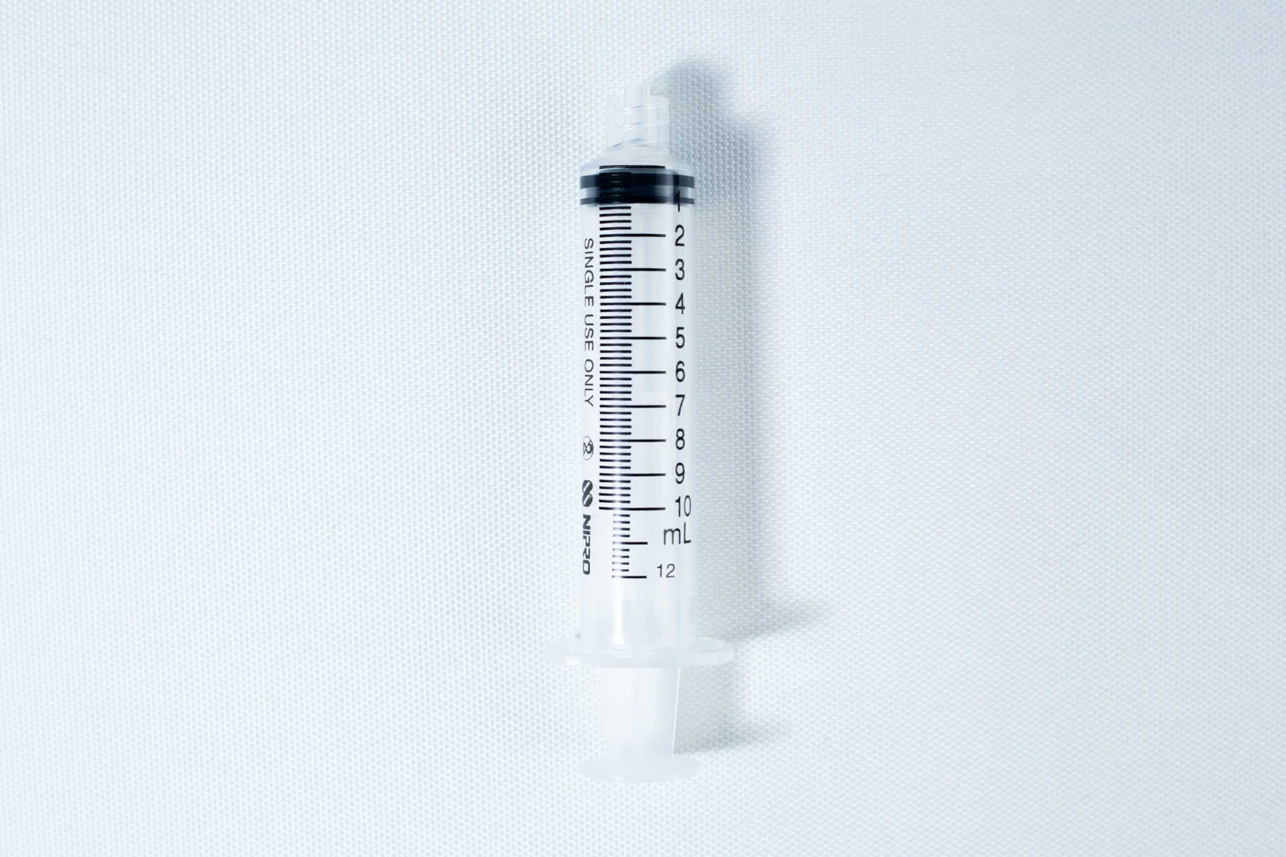 Liquid culture to Liquid culture expansion Kit 8 A clear plastic syringe with black measurement markings, placed on a white background.