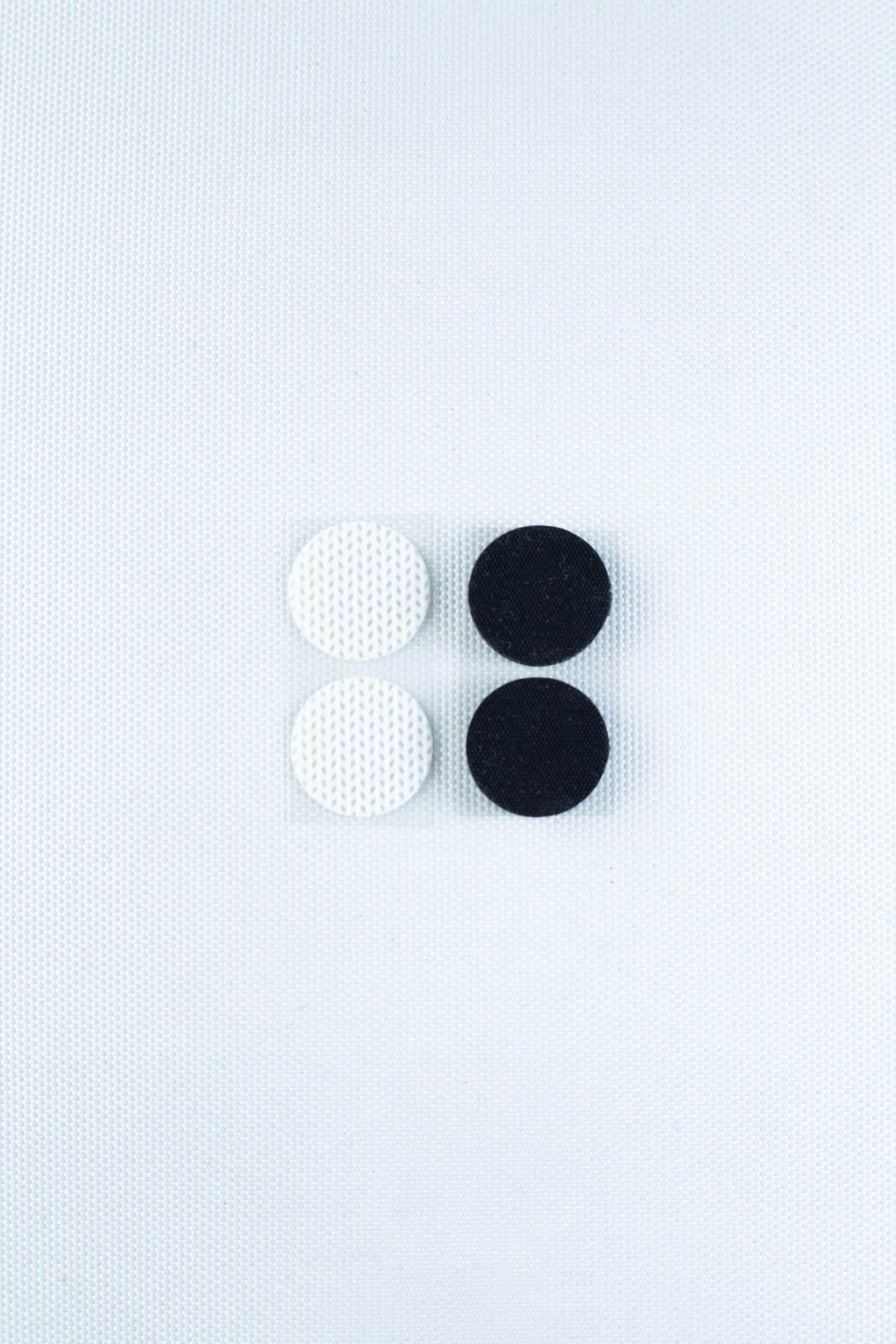 Self-healing injection port & Air Vent Filter-3M 8 The Self-healing injection port & Air Vent Filter-3M, featuring two white and two black textured components, is arranged in a square on a light textured background.