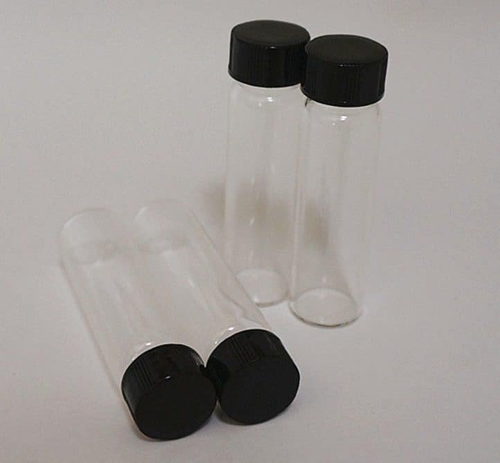 Clear Borosilicate Reagent Lab Glass bottle 50ml x 10pcs 2 Ten empty 50ml Clear Borosilicate Reagent Lab Glass bottles with black screw caps, arranged with some standing upright and some lying down.
