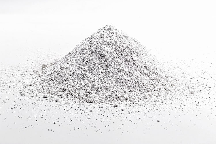 Calcium Carbonate for Mycology 1 A small mound of Calcium Carbonate for Mycology, a fine white powder, is scattered on a white surface with a plain background.