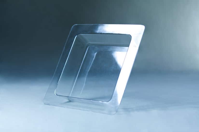 Mycelium Mold Growth form - Paver (Reusable) 3 A square, transparent plastic tray with a raised rim, inspired by the Mycelium Mould Growth form - Paver (Reusable), sits elegantly on a light blue surface and background.