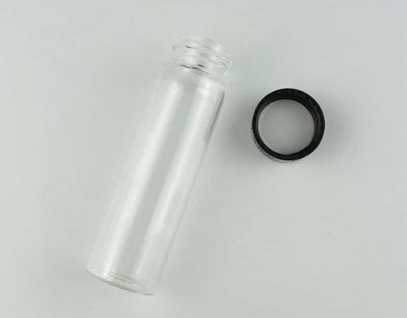 Clear Borosilicate Reagent Lab Glass bottle 50ml x 10pcs 3 A Clear Borosilicate Reagent Lab Glass bottle 50ml from the 10pcs set is shown lying next to a black screw cap on a white surface.