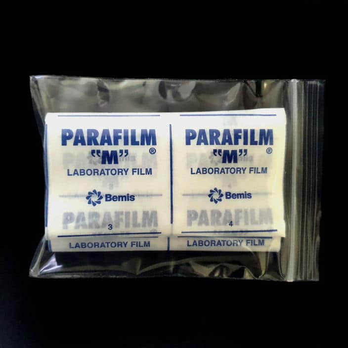 Parafilm Lab sealing film 6 A packet of Parafilm Lab sealing film is enclosed in a clear plastic bag, displayed against a black background.