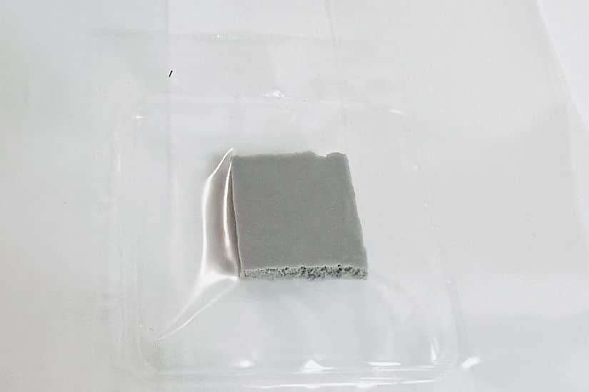 All in one Coco Coir+Vermiculite | organic rye | Millet | 1kg | 2kg Mushroom bag | Instruction 12 A small, square piece of grey material on a clear plastic tray against a white background.