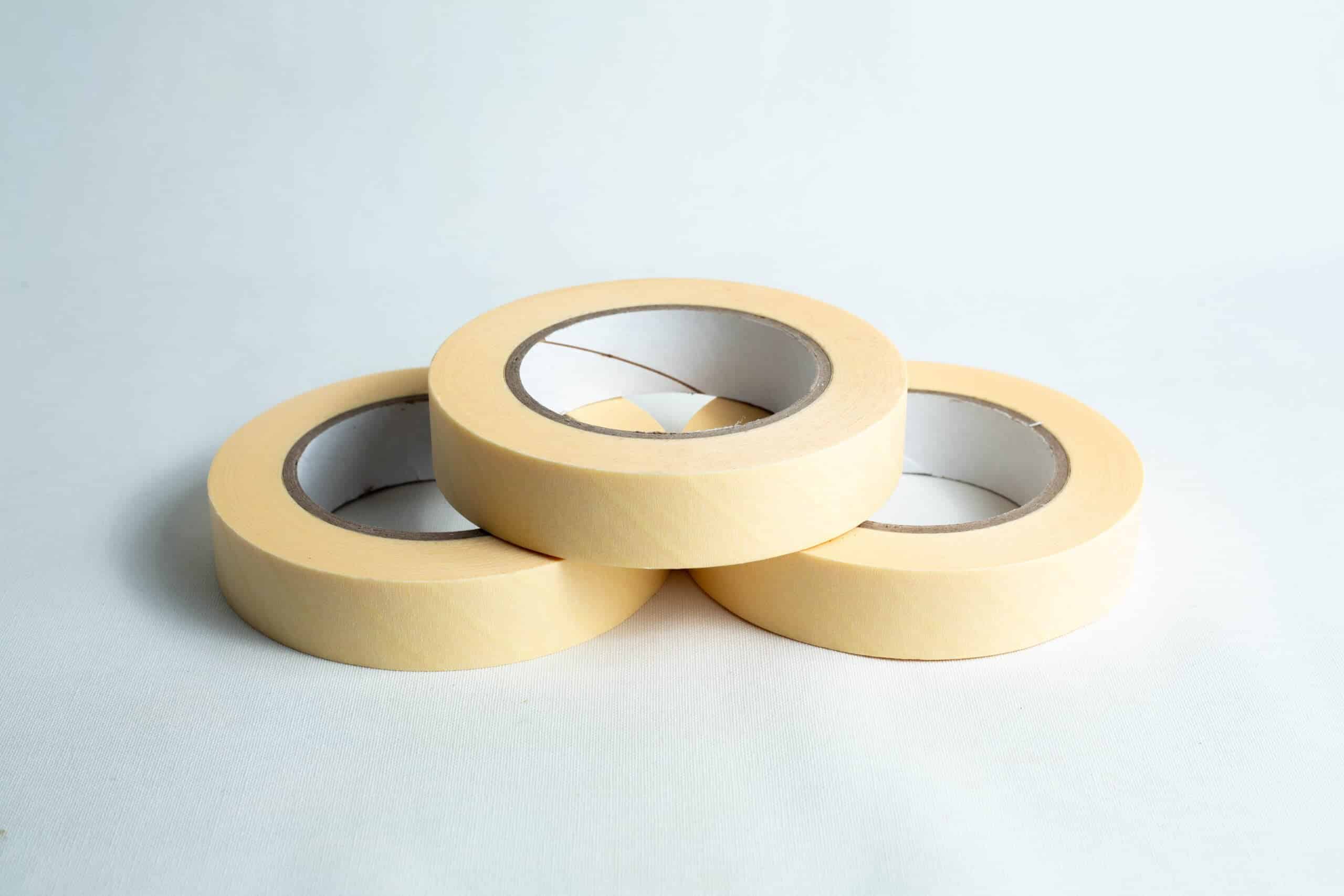 Autoclave sterilization indicator tape 25mm x 50 m 5 Three rolls of autoclave sterilisation indicator tape 25mm x 50m are arranged in a triangle on a white surface.