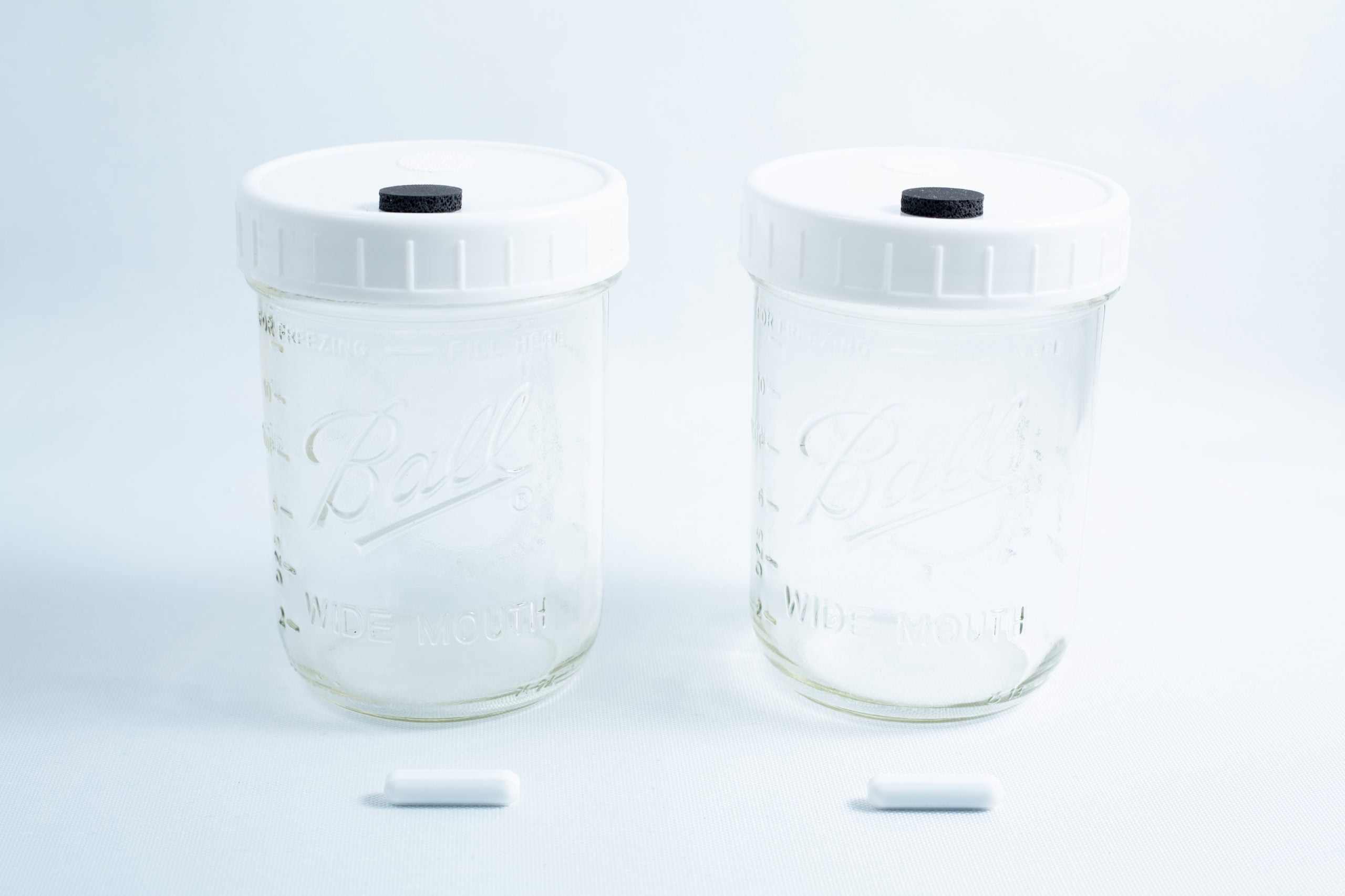 Liquid Culture Kit with Jar, Magnetic Stirrer and LC Mix 2 Two Mycology Ball mason jars, 1L each, genuine and autoclavable, with white lids featuring injection ports and air vents, displayed on a white background.