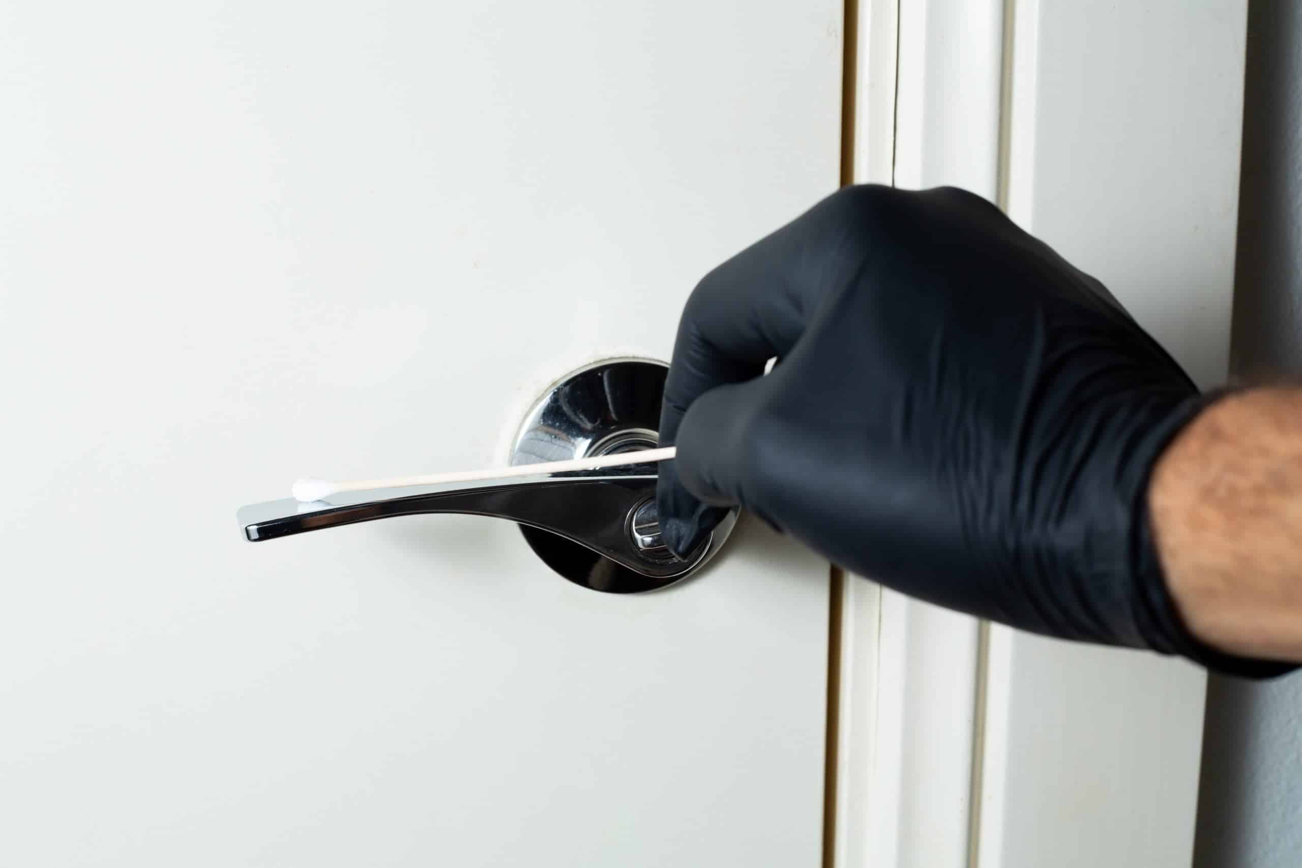 Agar petri dish MEA School Science Fun Project Kit 6 A gloved hand holds a cotton bud near a door handle, likely collecting evidence for a school experiment using the Agar Petri dish MEA School Science Fun Project Kit.