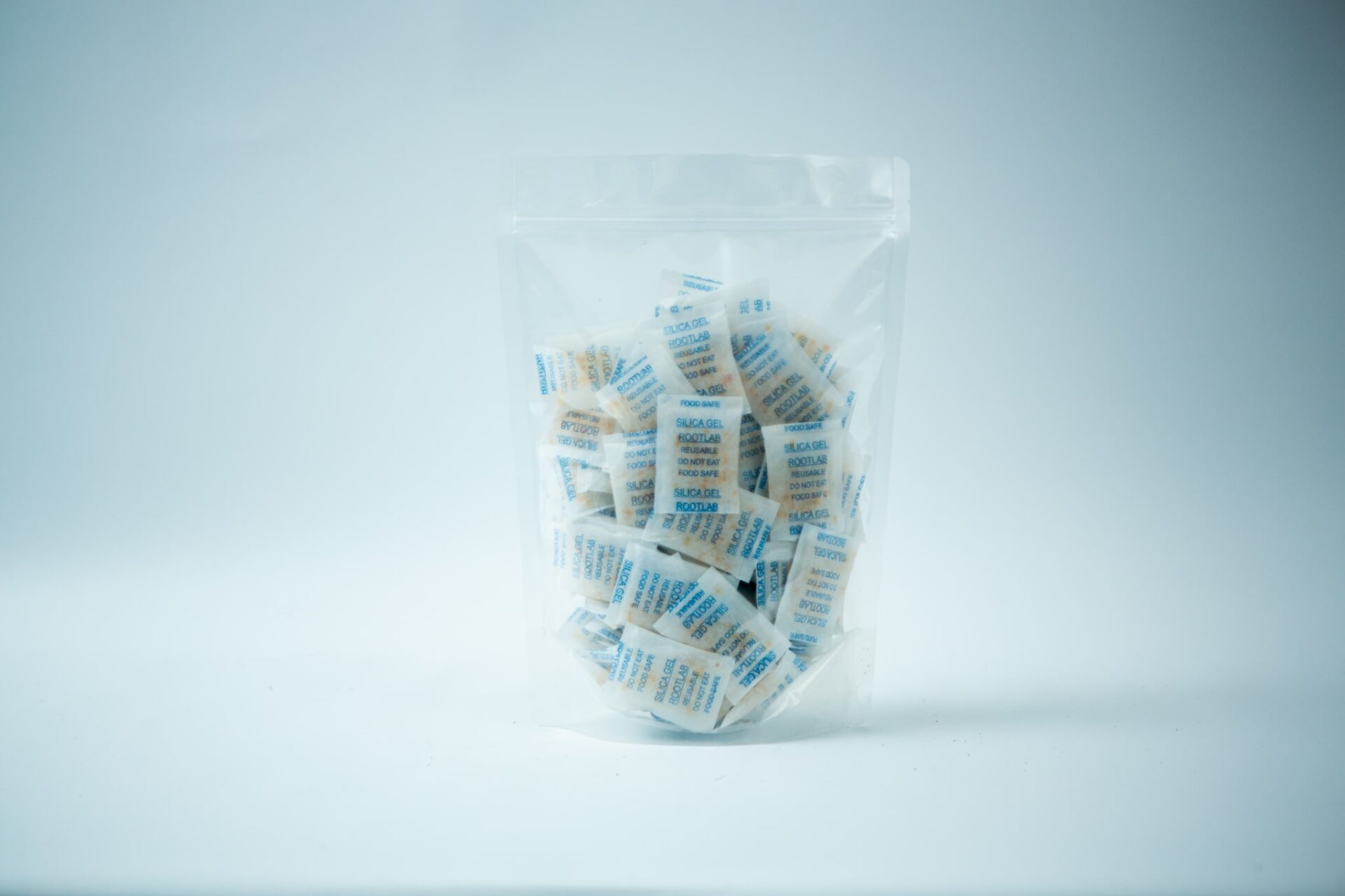 Desiccant Silica Gel 5gm | Reusable 1 A clear plastic bag containing Desiccant Silica Gel 5g | Reusable, with each packet individually wrapped, displayed on a white background.
