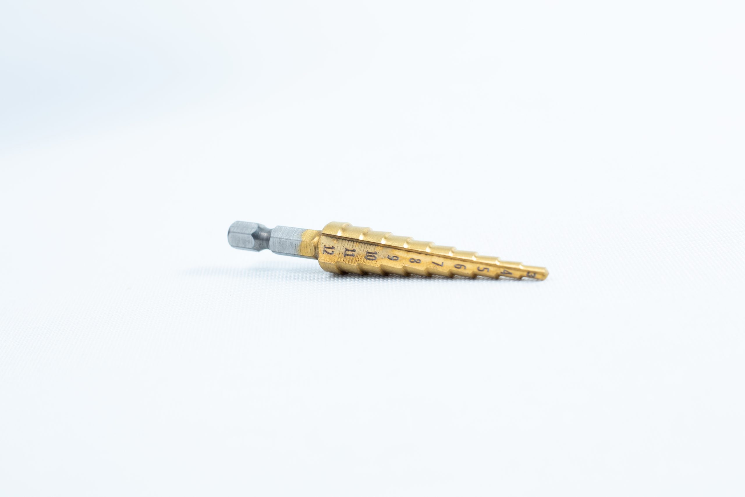 Drill Bit for holes size 3mm-12mm Titanium Coated 1 A Drill Bit for holes size 3mm–12mm, Titanium Coated with size markings, is shown lying on a plain white background.
