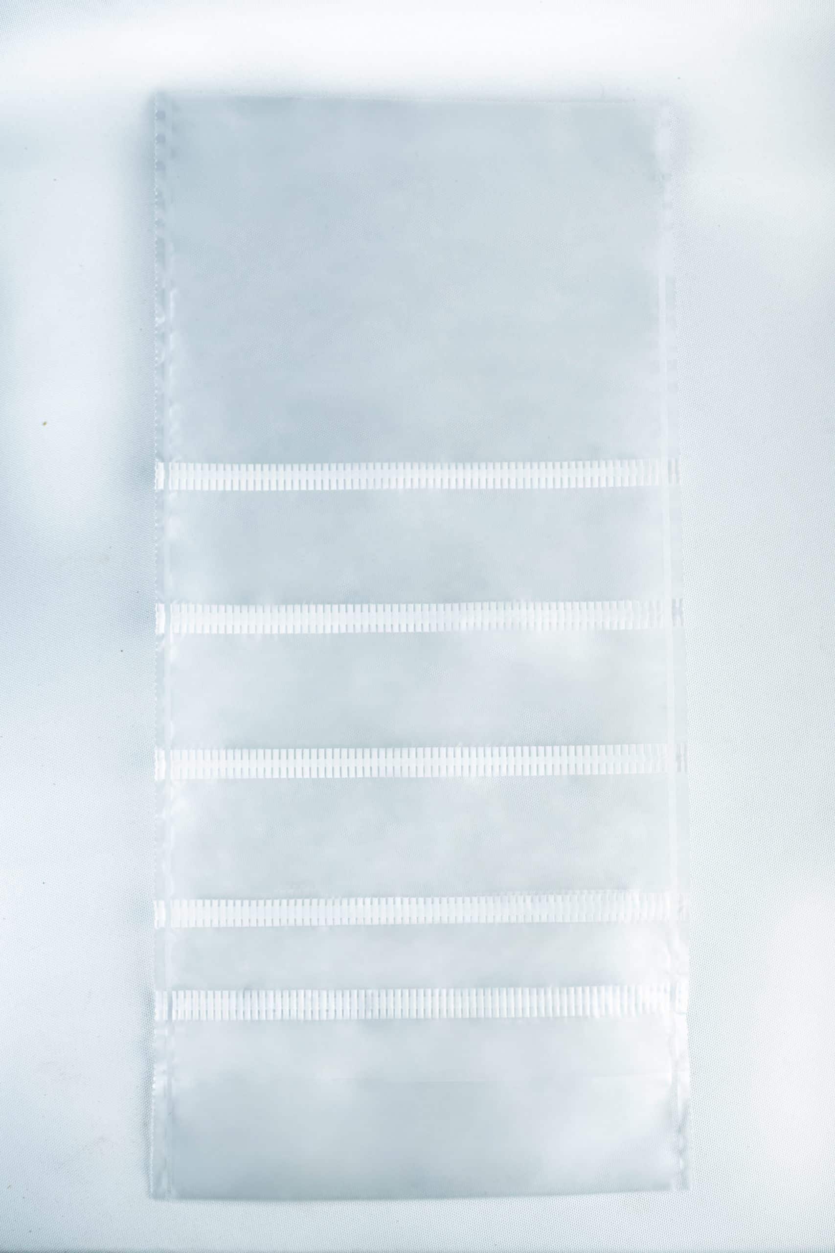 Grow bags Mushroom Sac O2 3 A clear plastic sheet with six horizontal pockets, ideal for organising your Mushroom Grow Bags Unicorn for spawn and substrate, set against a white background.