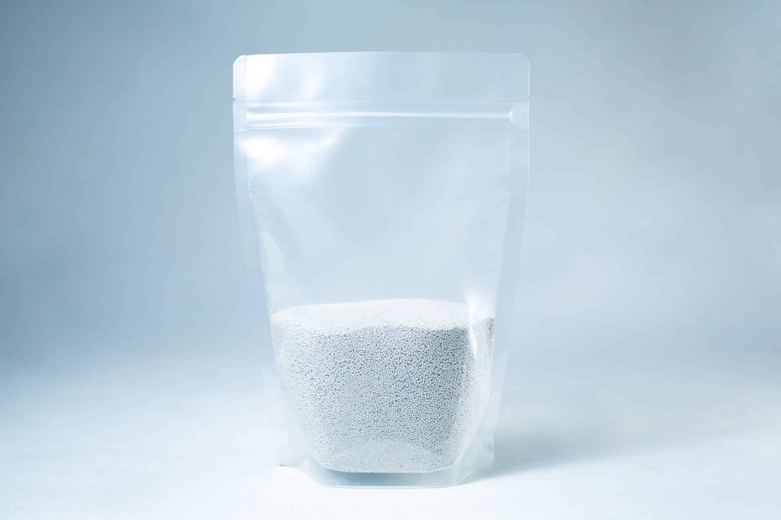 Natural Gypsum coarse grade mushroom supplement grain and substrate 1 A clear resealable pouch containing white coarse Natural Gypsum mushroom supplement grain and substrate stands on a light background—perfect for storage and use.
