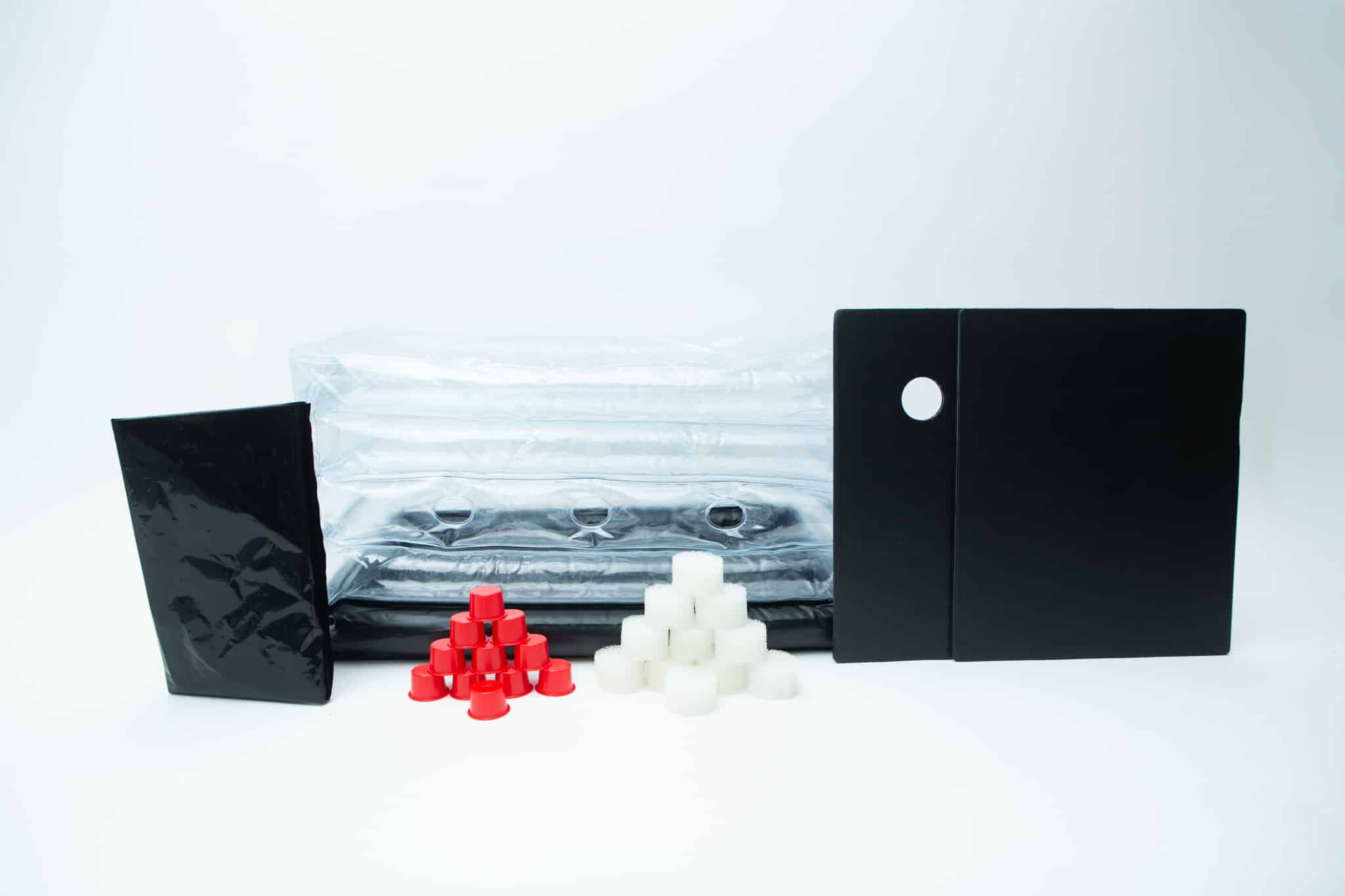 Inflatable monotub kit for Growing mushrooms- Boomer Shroomer V 2.0 1 Assorted black, red, and white plastic parts and sheets arranged on a white background—perfect components for assembling your Inflatable monotub kit for Growing mushrooms – Boomer Shroomer V 2.0.