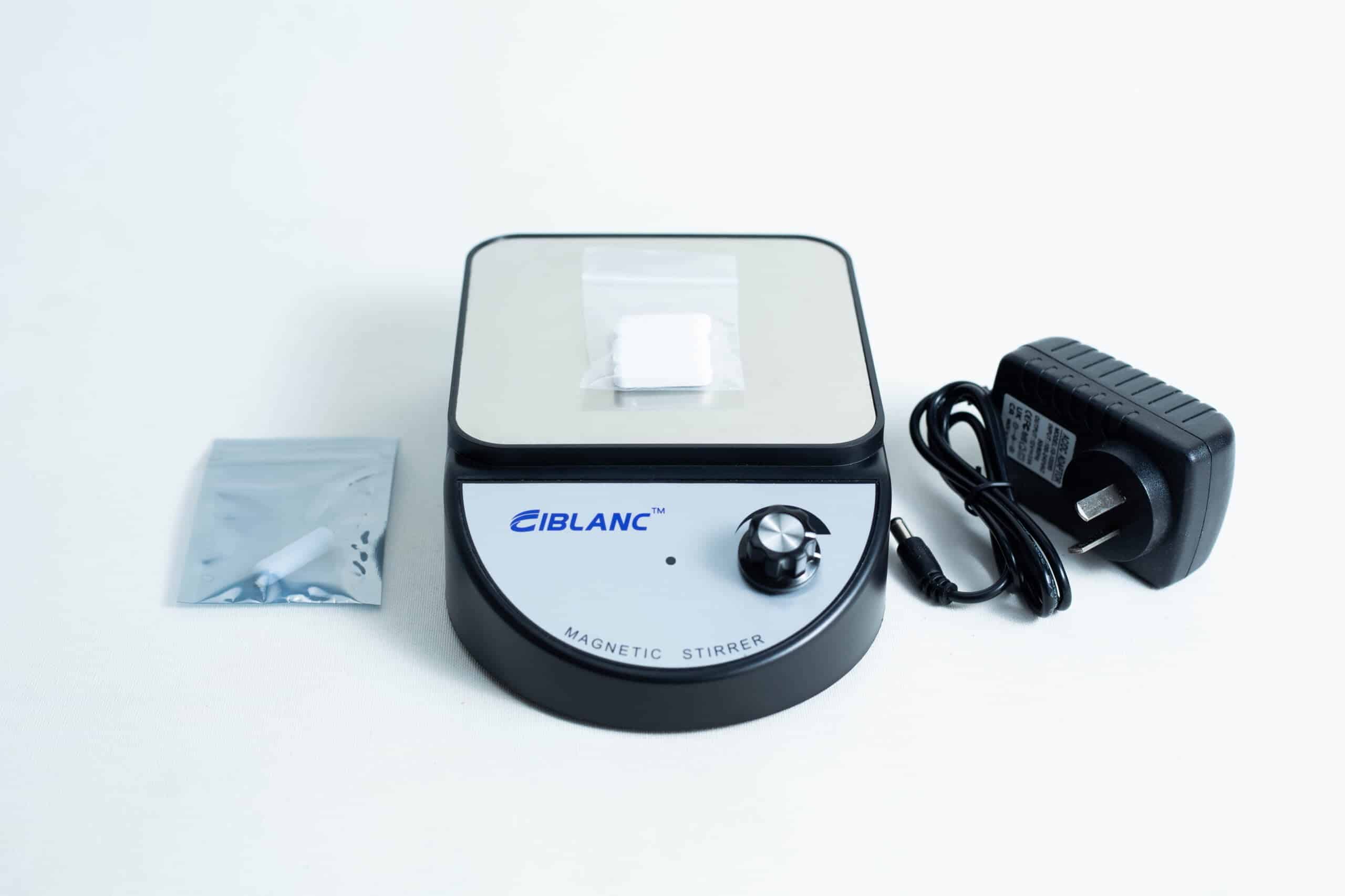 Magnetic Stirrer Ciblanc 3500rpm 2 The Magnetic Stirrer Ciblanc 3500rpm is shown on a white background with a power adaptor and a small bag containing a magnetic stir bar.