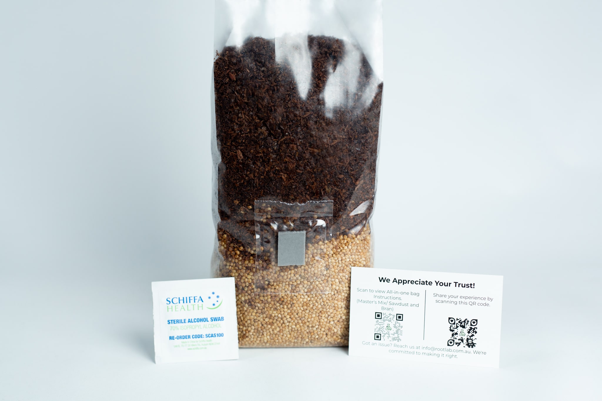 All In One Sawdust & Bran | Millet Mushroom 1kg Bag | Instruction 1 A clear 1kg Masters Mix + Millet All-in-one Mushroom Bag filled with brown and yellow seeds, shown with two small info cards in front.