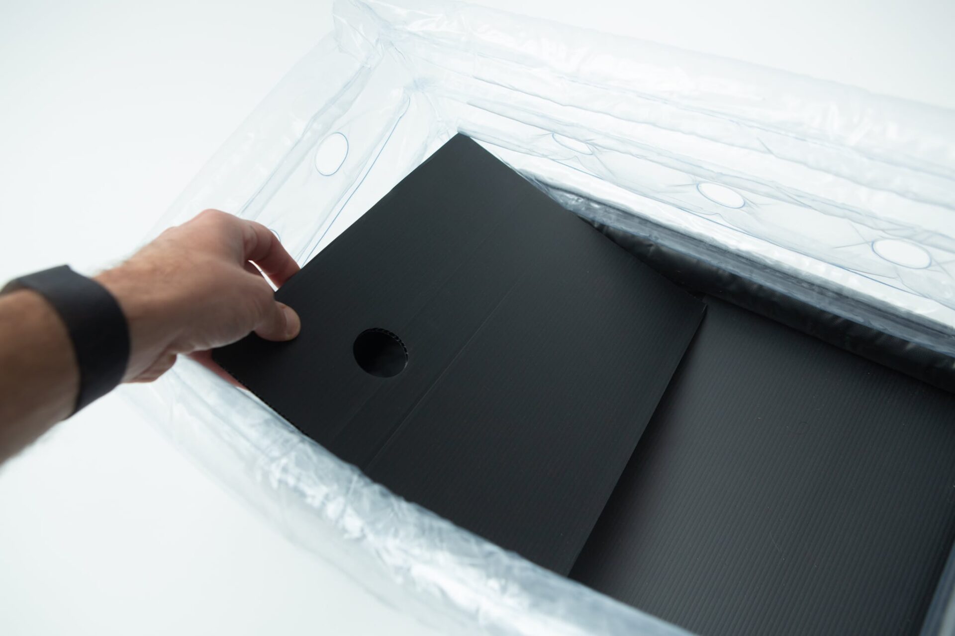 Inflatable monotub kit for Growing mushrooms- Boomer Shroomer V 2.0 12 A hand places a black sheet with a hole into the Boomer Shroomer V 2.0 inflatable monotub kit for growing mushrooms.