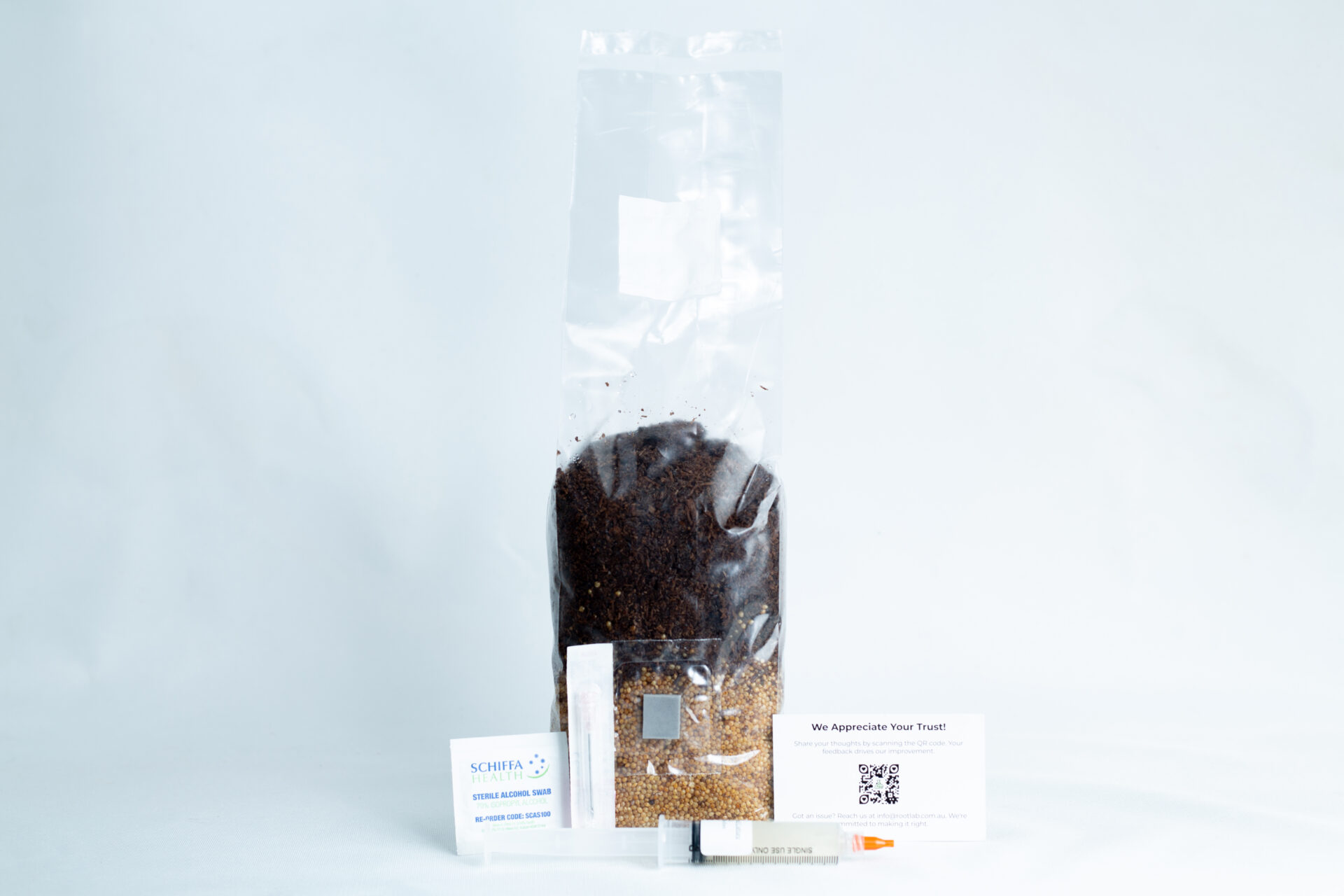 Lion's Mane Mushroom Grow Kit 4 A 1kg Masters' Mix + Millet All-in-One Mushroom Bag stands on a white background, with business cards and a syringe displayed in front.