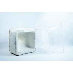 A white, square, hollow packaging block is next to a clear plastic mould on a white background, showcasing the Mycelium Mould Growth Form - Plant pot Heavy Duty (Reusable).