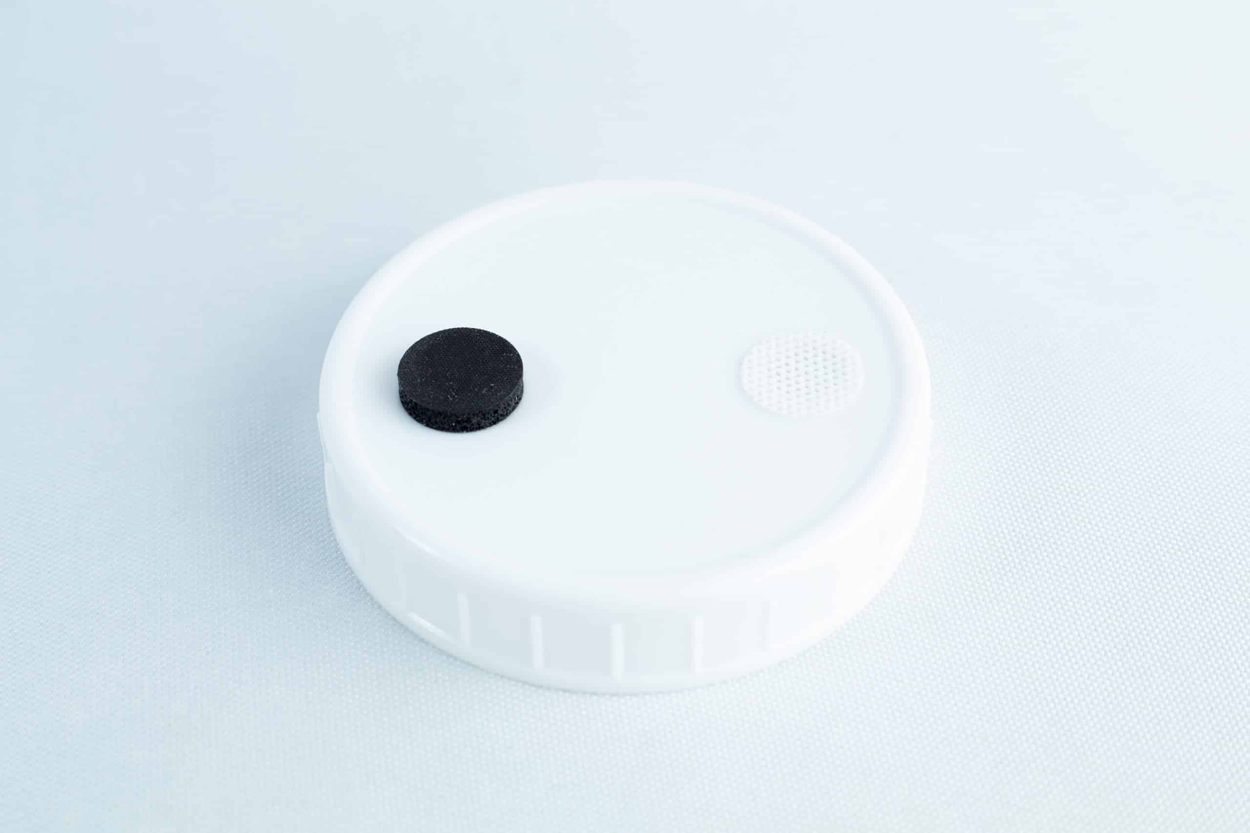 Self-healing injection port & Air Vent Filter-3M 2 The Self-healing injection port & Air Vent Filter-3M is a white plastic lid with a black self-healing injection port and a small white air vent filter on top, shown against a light background.