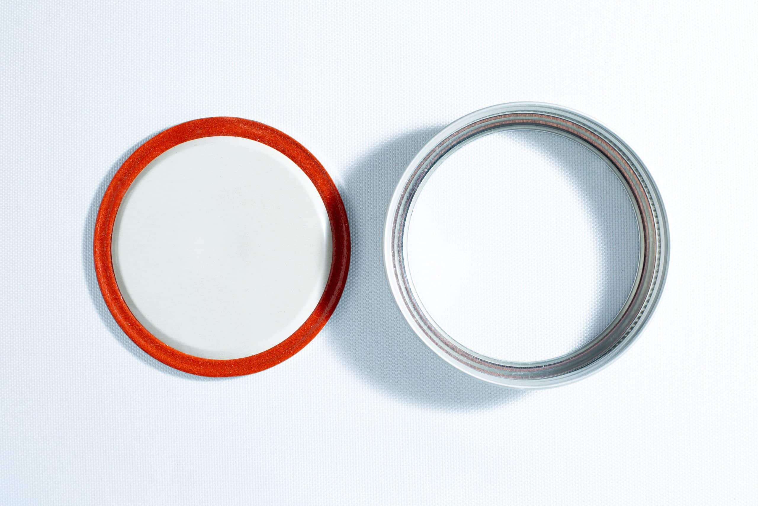 Metal lid and band set for wide mouth mason jar | 86mm 1 The Self-healing injection port & Air Vent Filter-3M, with a metal ring, are displayed side by side on a white surface.