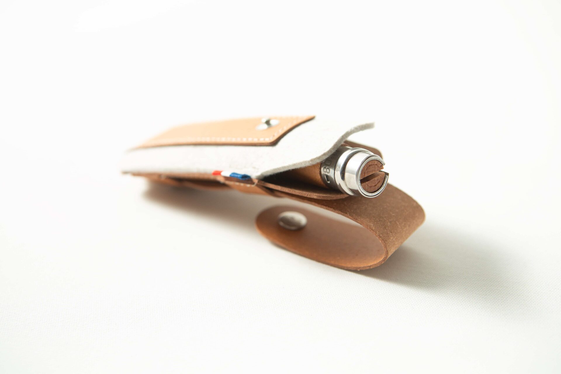 Opinel Sheath - Brown 3 A brown Opinel Sheath holds a metallic pen, photographed on a white background.