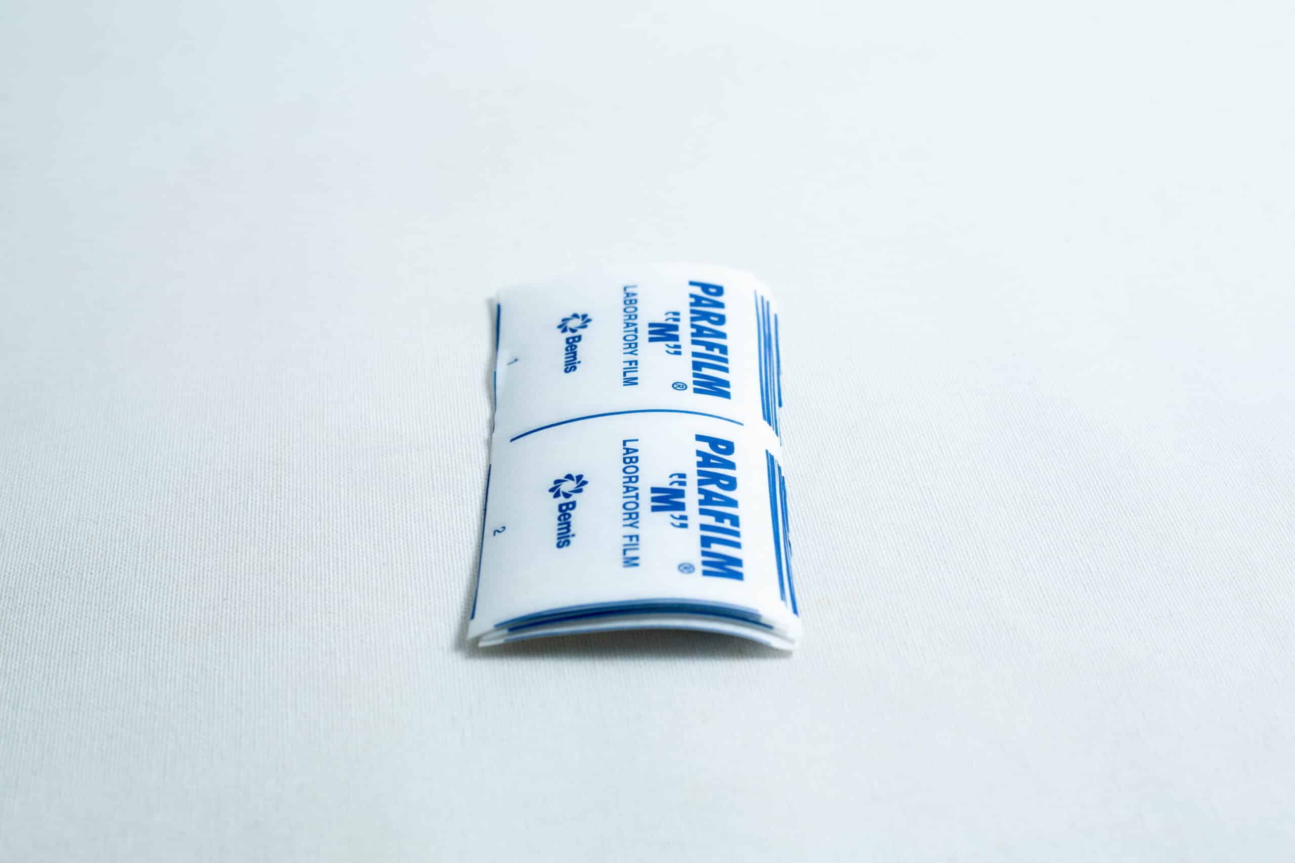 Pre-cut parafilm strips 10x Lab cut film 2 Pre-cut Parafilm strips 10x lab cut film rest on a white surface, making it easy to quickly seal lab containers without the need to cut Parafilm strips by hand.