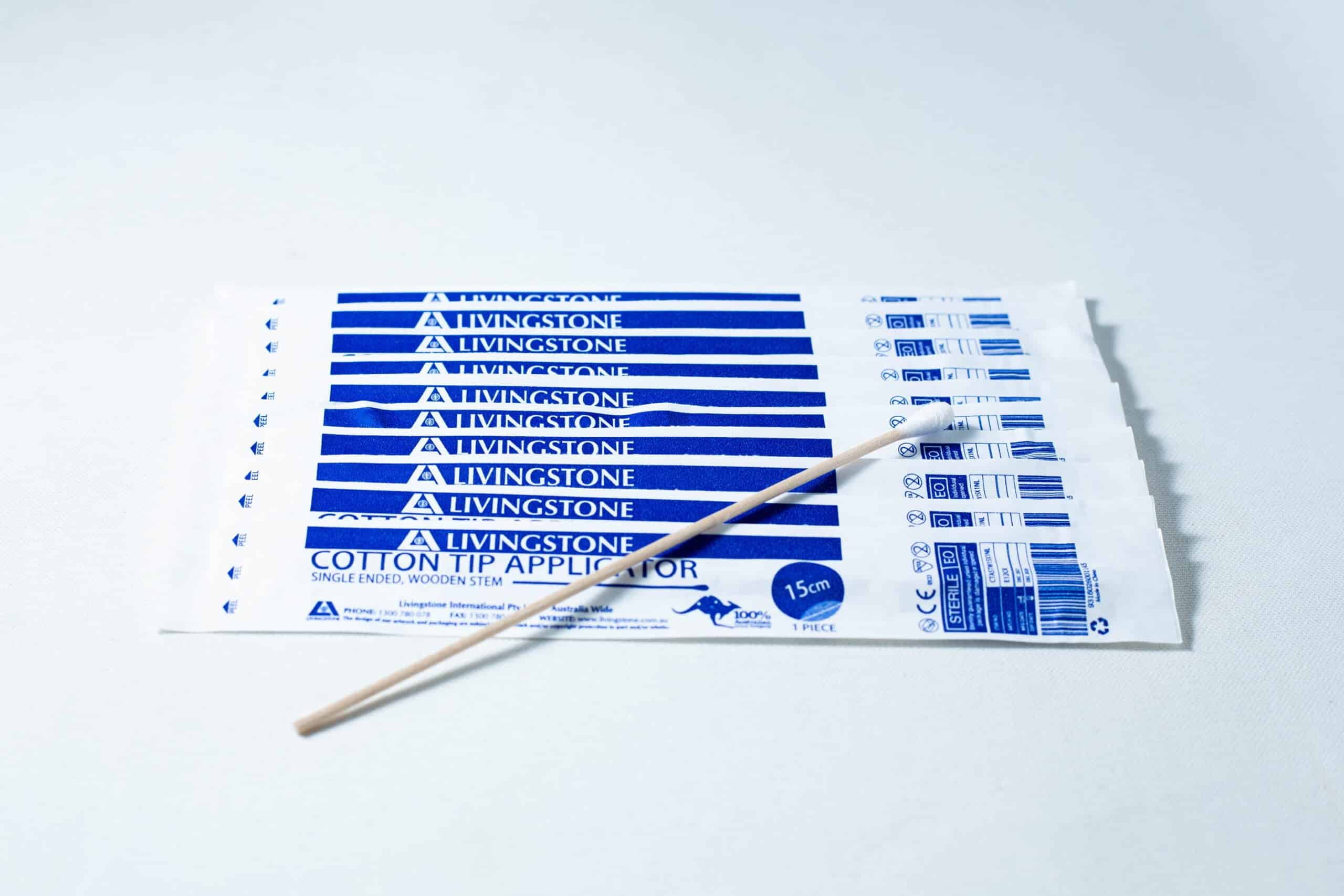 Sterile Cotton Tip Applicator/ Swab 1 Eight packs of Sterile Cotton Tip Applicator/Swab in blue and white, each containing one sterile cotton tip swab, with a single wooden applicator on top.