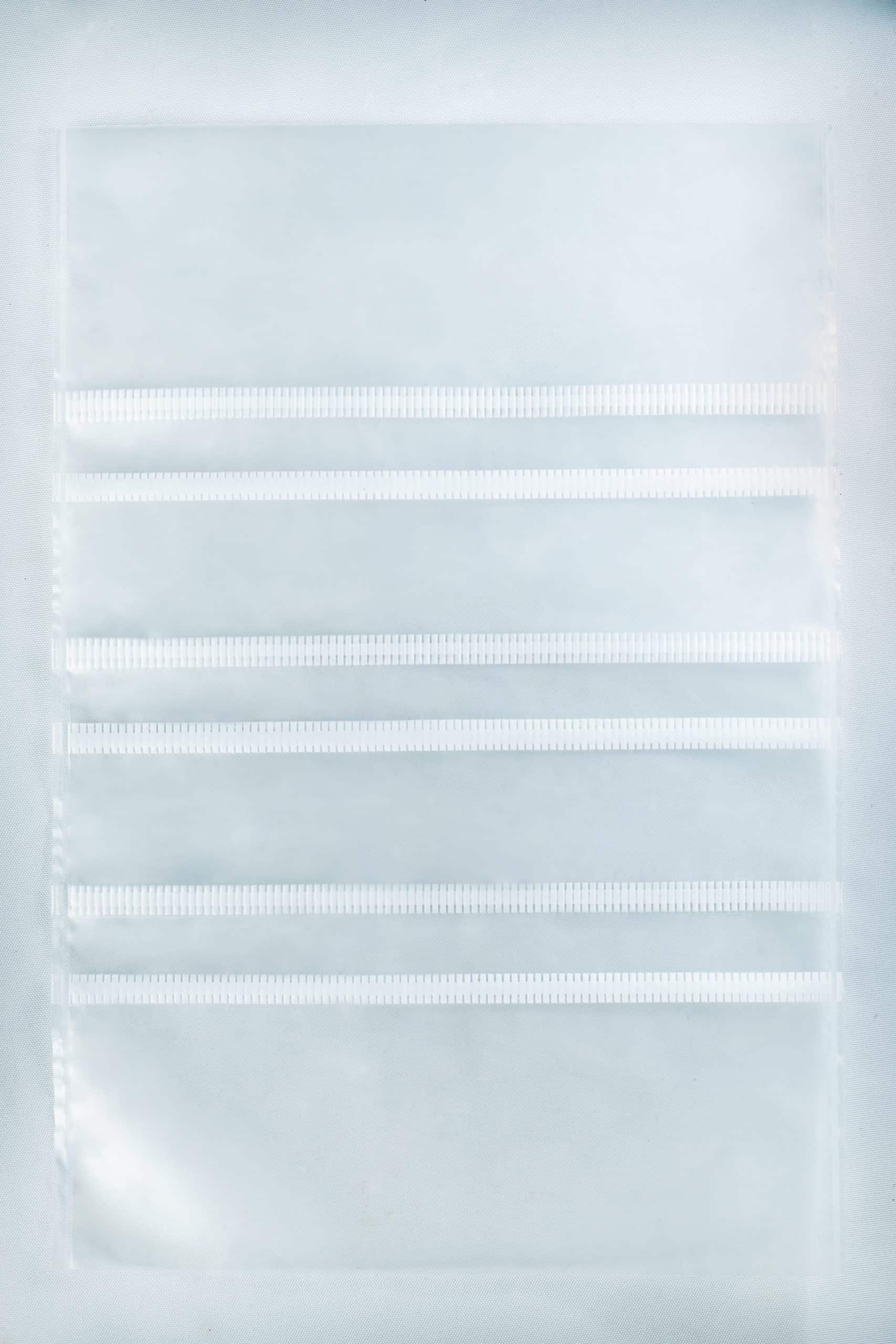 Grow bags Mushroom Sac O2 2 A clear plastic sheet with four horizontal pocket strips, perfect for organising supplies like Mushroom Grow Bags Unicorn for spawn and substrate or other mushroom grow bag essentials.