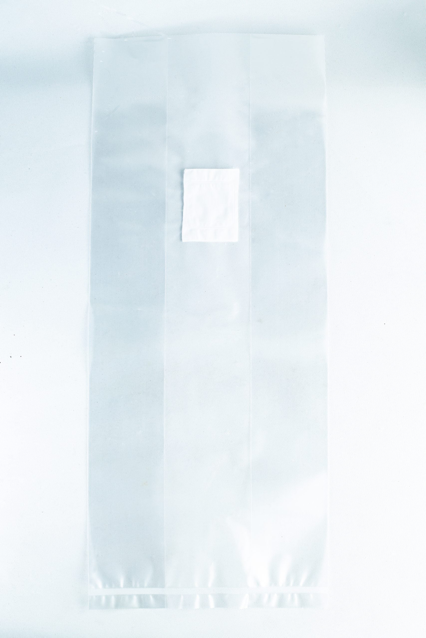 Unicorn Mushroom Grow Bags for spawn and substrate 3 A small white square sits on a large transparent sheet made of material used in Mushroom Grow Bags Unicorn for spawn and substrate, all placed on a white background.