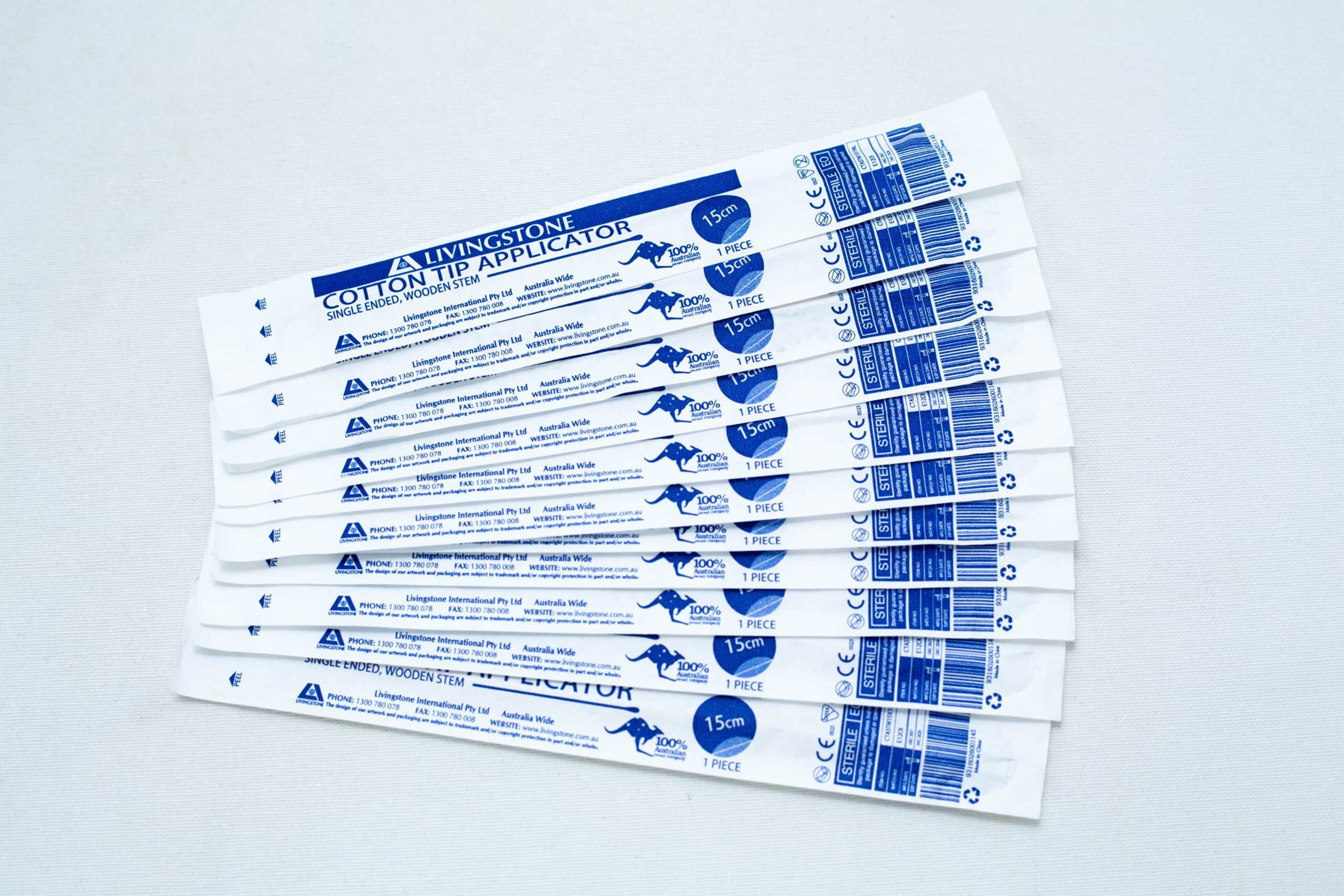 Sterile Cotton Tip Applicator/ Swab 4 Ten packaged sterile cotton tip applicator/swab are fanned out on a white surface.