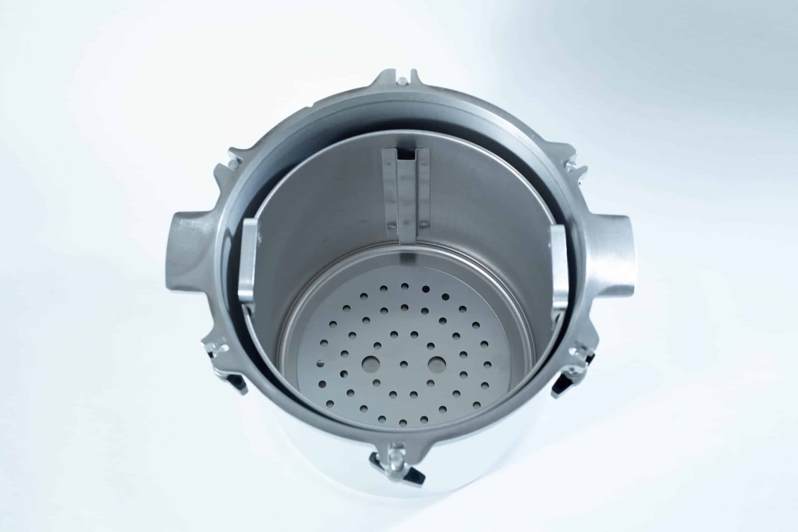 1925x All-American Sterilizer (Autoclave) 25 quart/ 24 Liter 4 Top view of an empty stainless steel autoclave chamber with a perforated metal tray inside.