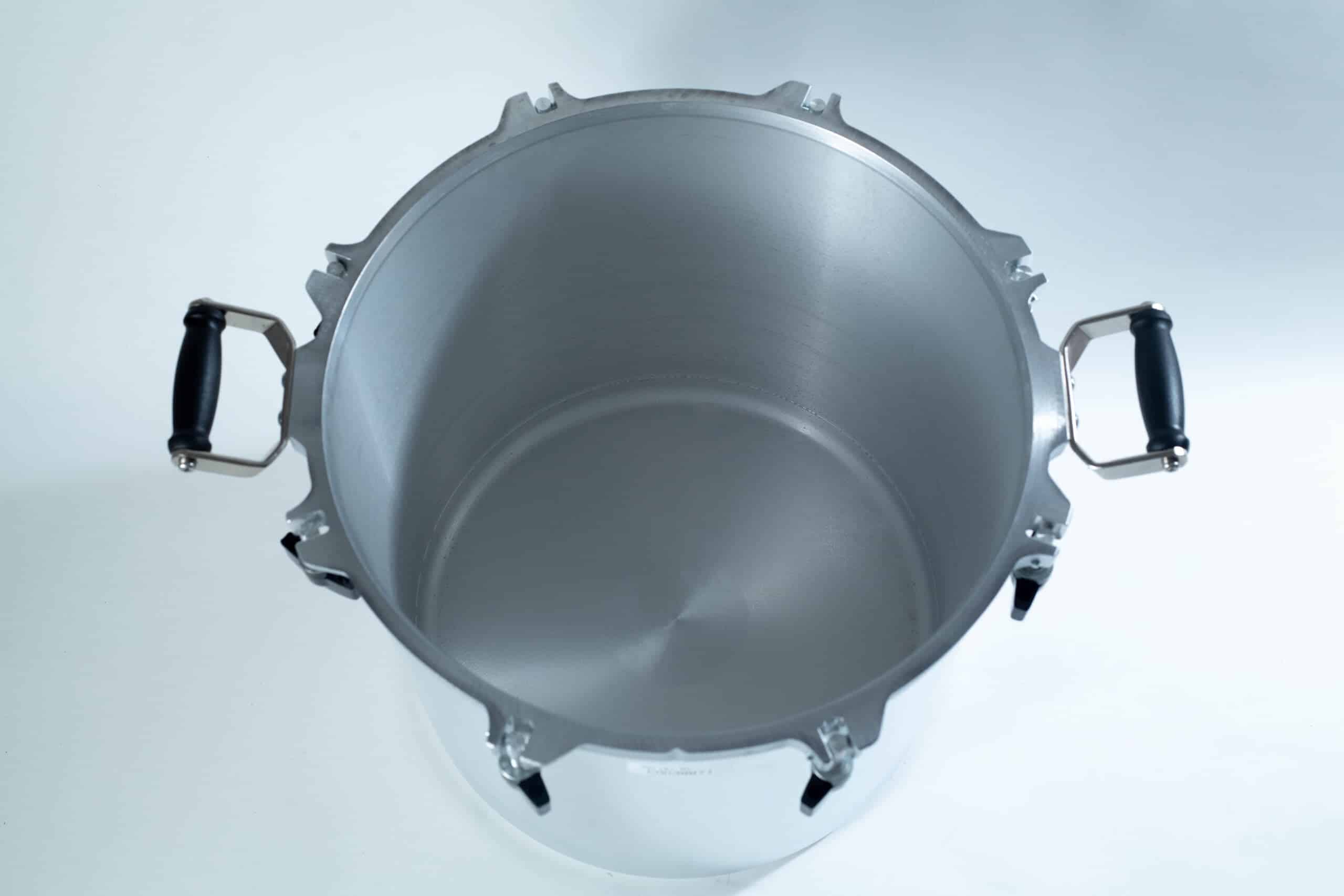 1941x All-American Sterilizer (Autoclave) 41 quart/ 39 liters. 5 Top view of an empty stainless steel pressure cooker with black handles on a white surface.
