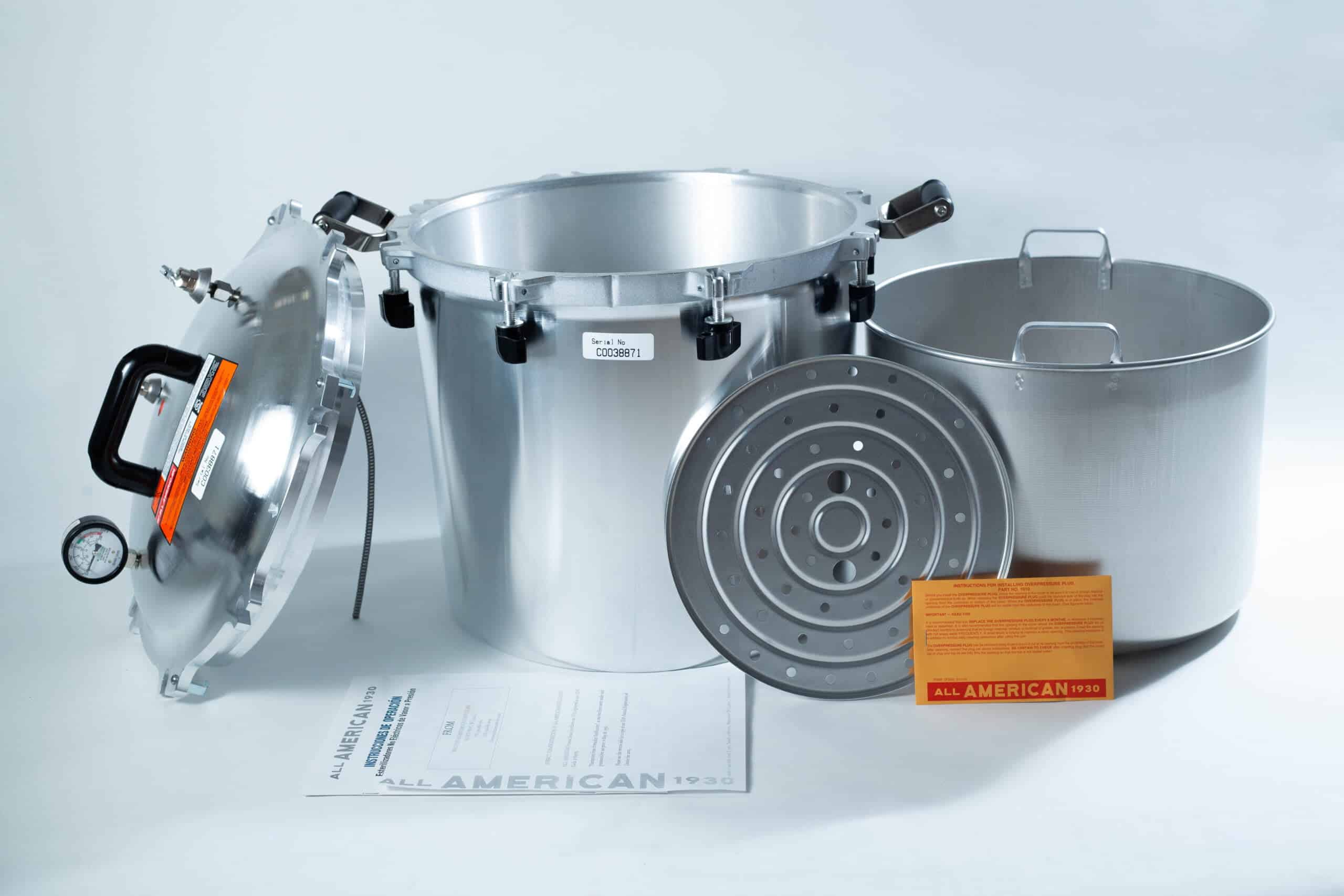 1941x All-American Sterilizer (Autoclave) 41 quart/ 39 liters. 3 All American pressure cooker with lid, inner pot, metal rack, instruction manual, and orange card displayed.