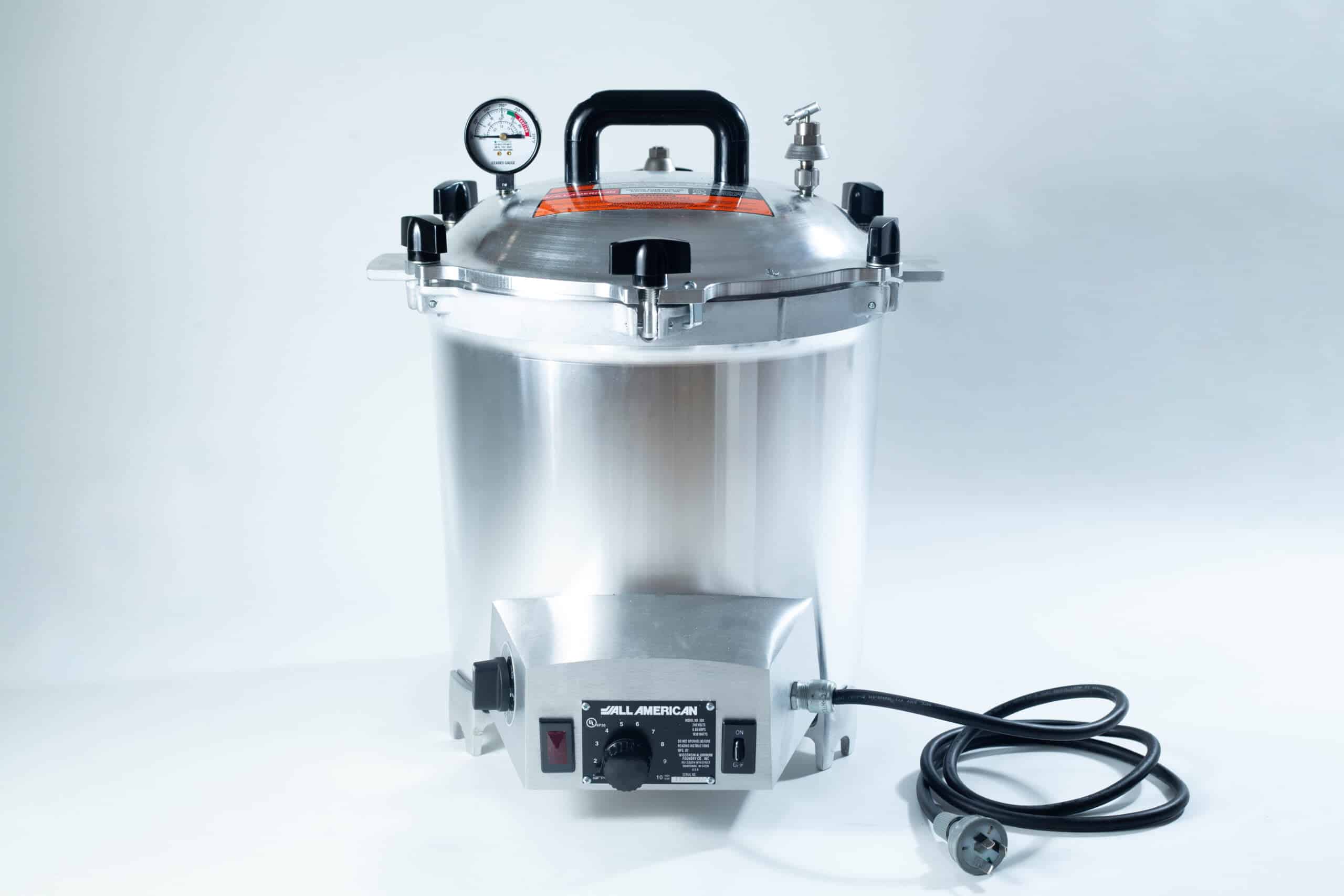 All American 2180 Support Base for 25X and 50X Sterilizers 3 A silver electric pressure cooker with a gauge, black handle, knobs, and a power lead on a white background.
