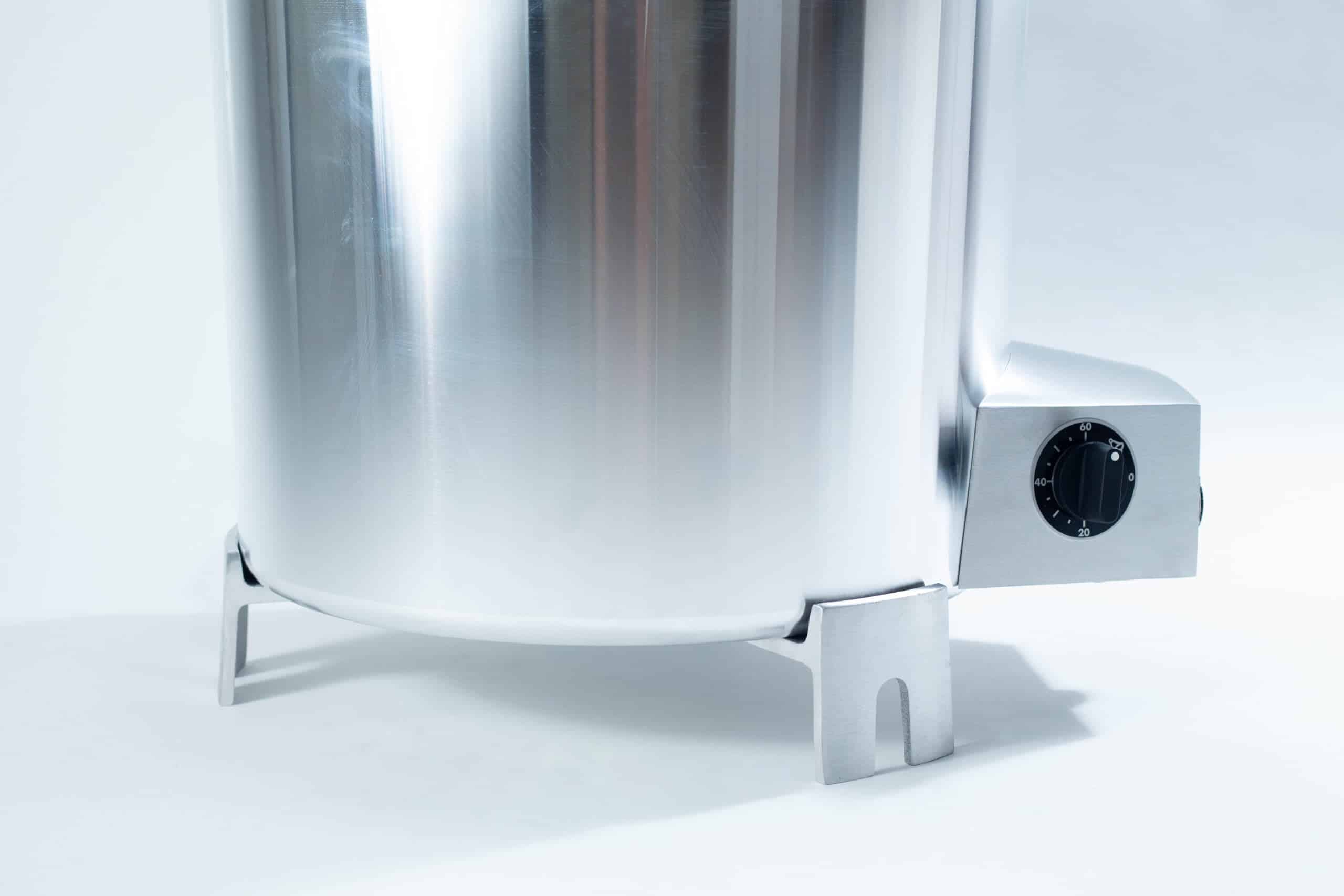 All American 4180 Support Base for 75X Sterilizers 4 Close-up of a shiny stainless steel appliance with a black dial, shown on a white background.