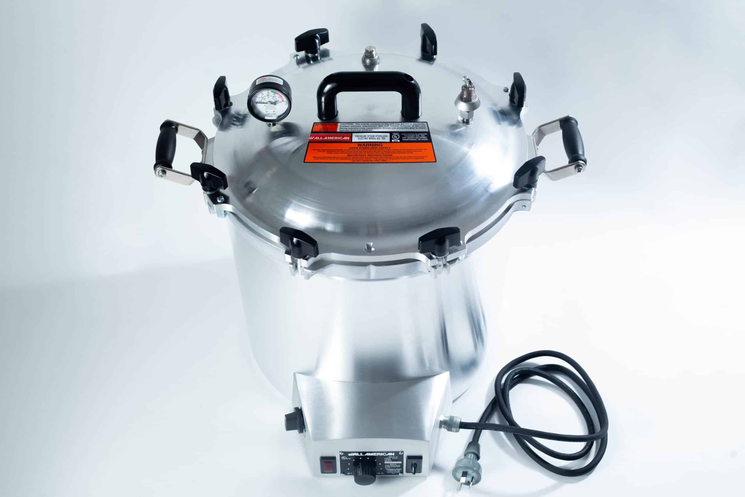 75x All American electric autoclave sterilizer 41 quart 2 Large stainless steel pressure cooker with a gauge, black handles, and an attached power lead.