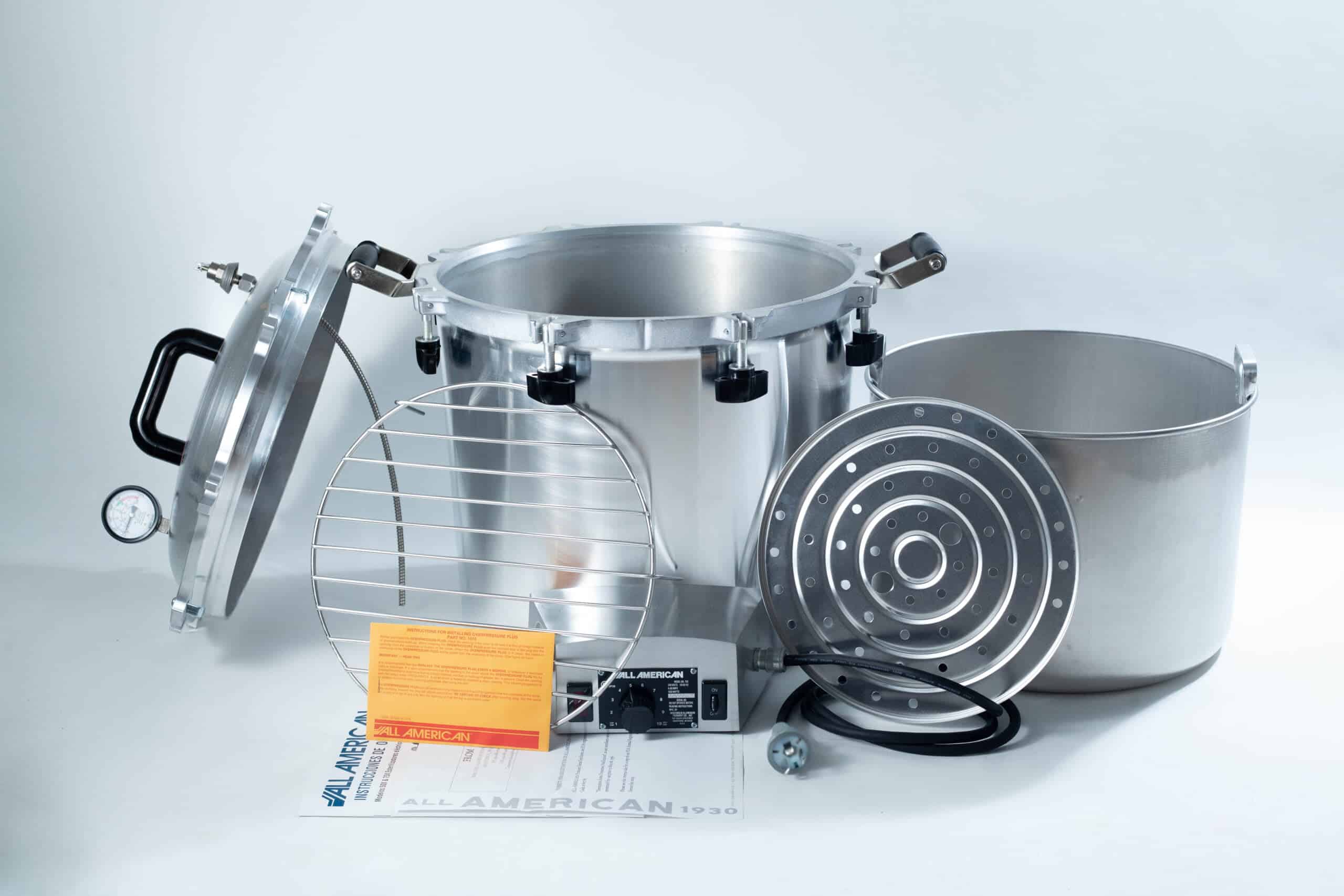 75x All American electric autoclave sterilizer 41 quart 4 Large silver autoclave with lid, metal rack, inner pot, instructions, and power lead displayed on a white background.