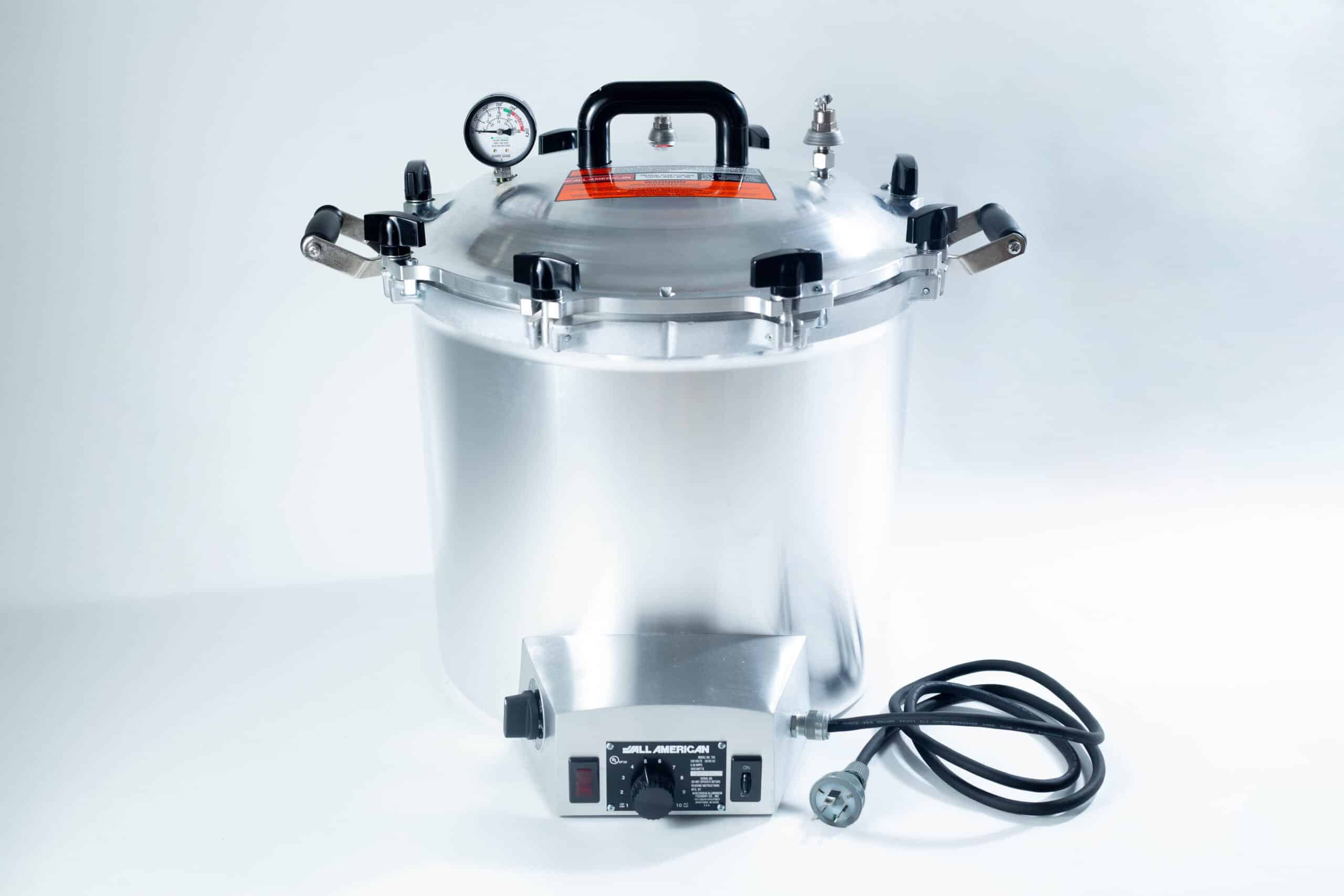 75x All American electric autoclave sterilizer 41 quart 1 The All-American Wingnut is a large silver pressure cooker featuring gauge, latch handles, and a black power lead, shown on a white background.