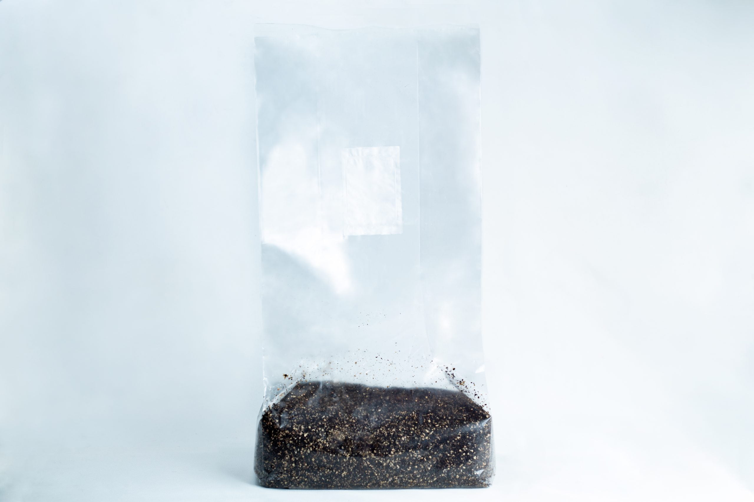 CVG Substrate | CVG Monotub Mushroom Bulk Substrate | Coco Verm Gypsum 2 The CVG Substrate | CVG Monotub Mushroom Bulk Substrate 2KG Coco Verm Gypsum is shown as a clear plastic bag of dark substrate, perfect for mushroom cultivation, set against a plain white background.