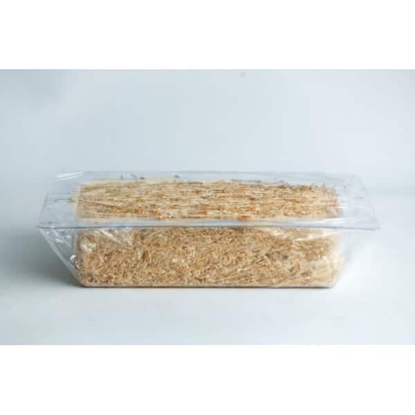 A block of shredded wheat cereal in a clear plastic tray with a transparent wrapper.