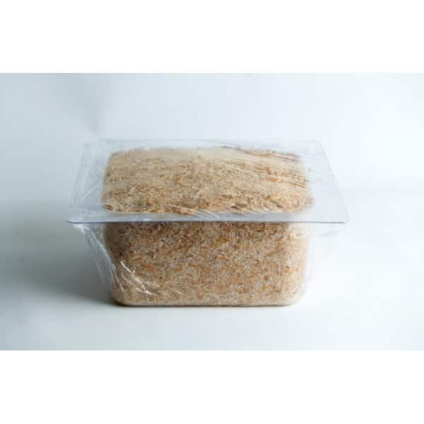 A clear plastic container filled with grated cheese, covered with cling film, on a white background.