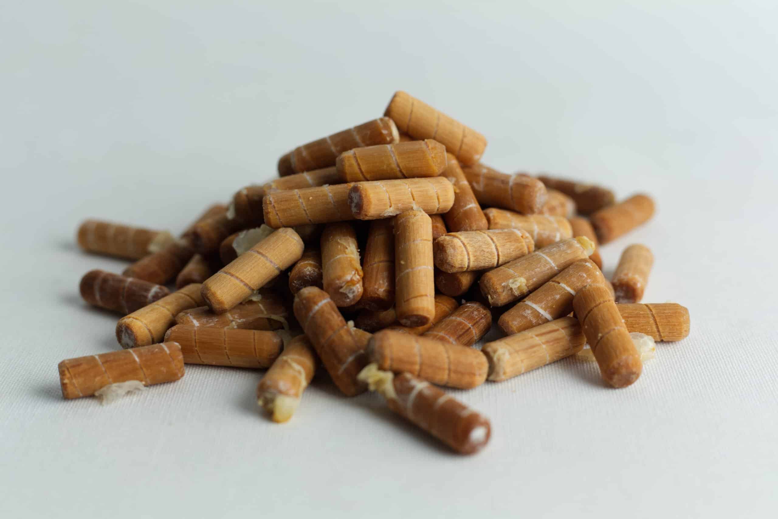 Log Dowel Mushroom Plug Spawn | Native Australian Reishi | Ganoderma steyaertanum 2 A pile of Log Dowel Mushroom Plug Spawn—Native Australian Reishi (Ganoderma steyaertanum) pellets is shown on a white surface.