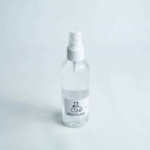 A clear 100ml spray bottle labelled ROOTLAB with a laboratory flask logo, containing 70% isopropyl alcohol, is placed on a white background.