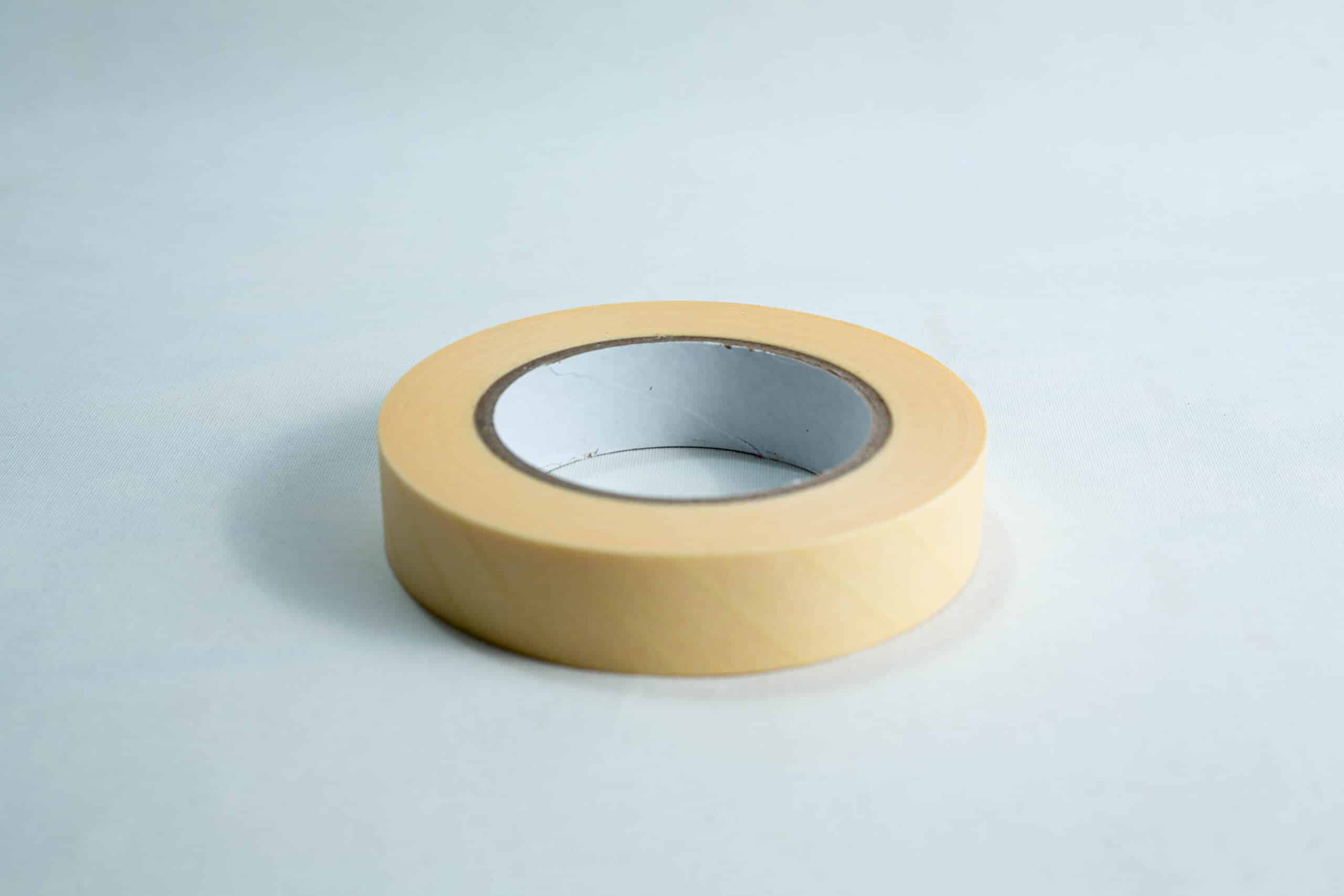 Autoclave sterilization indicator tape 25mm x 50 m 1 A roll of beige masking tape on a white surface.