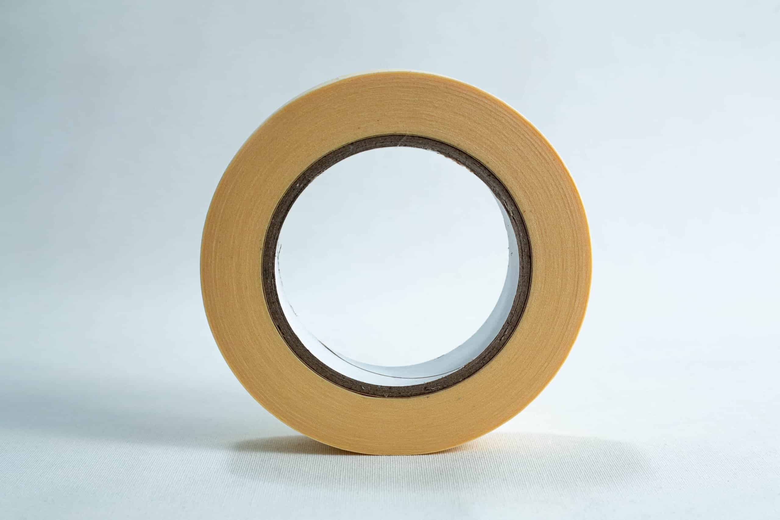 Autoclave sterilization indicator tape 25mm x 50 m 3 A roll of beige masking tape stands upright on a white surface against a light background.