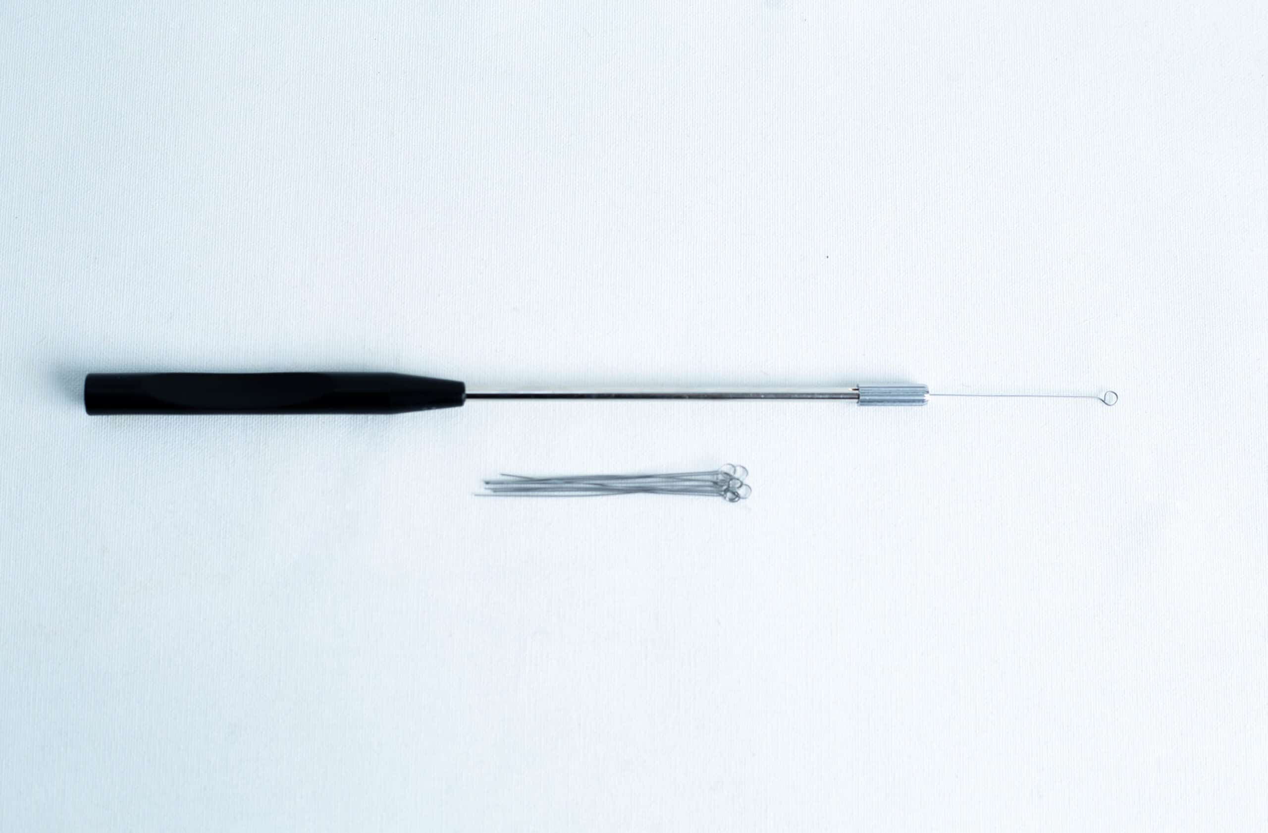 Inoculation Rod with Loops 4 A black-handled inoculation loop and several metal loops on a white background.