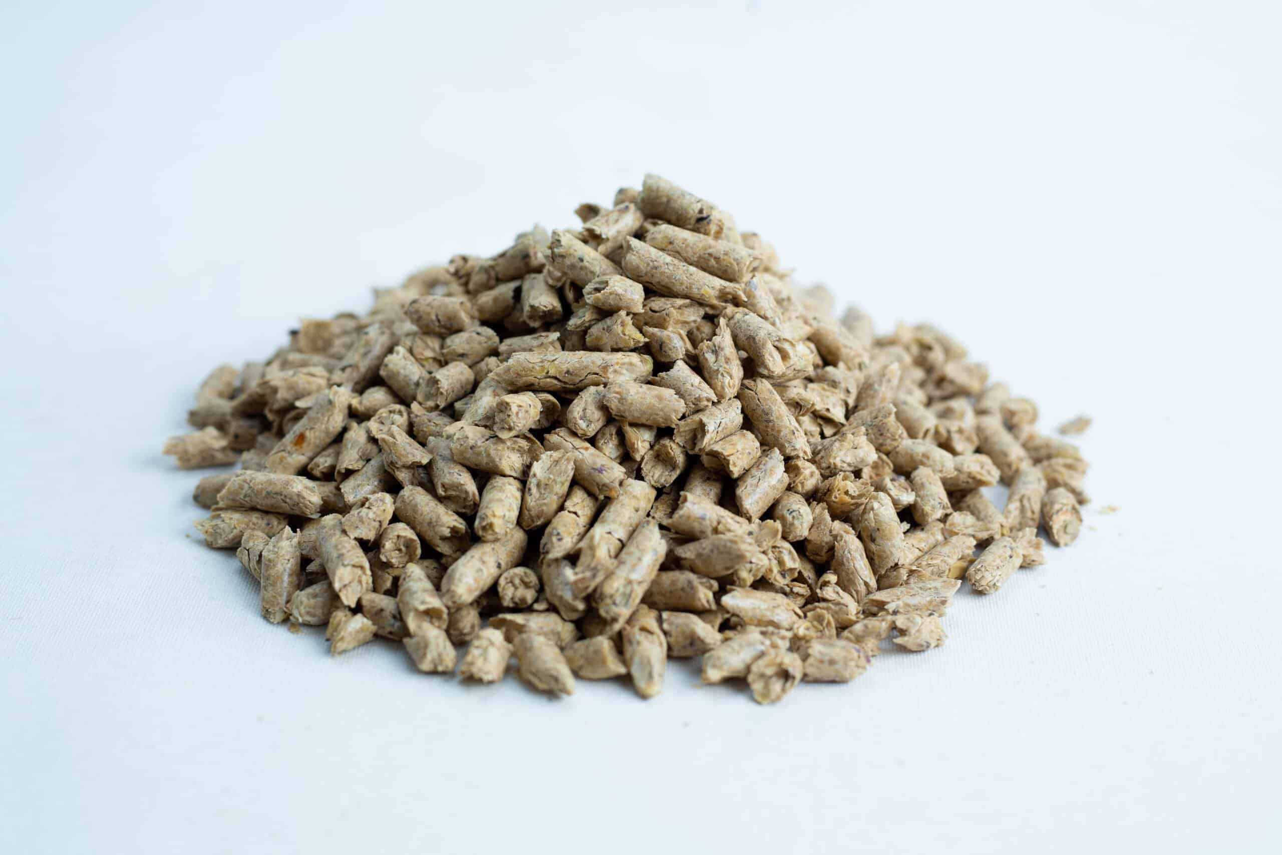 Soy Hull Pellets Non-GMO 20KG Australian Grown (HyFeed HyFibre) 2 A pile of Maxisoy Soya Hull Pellets animal feed (20kg), light brown in colour, rests on a white background.