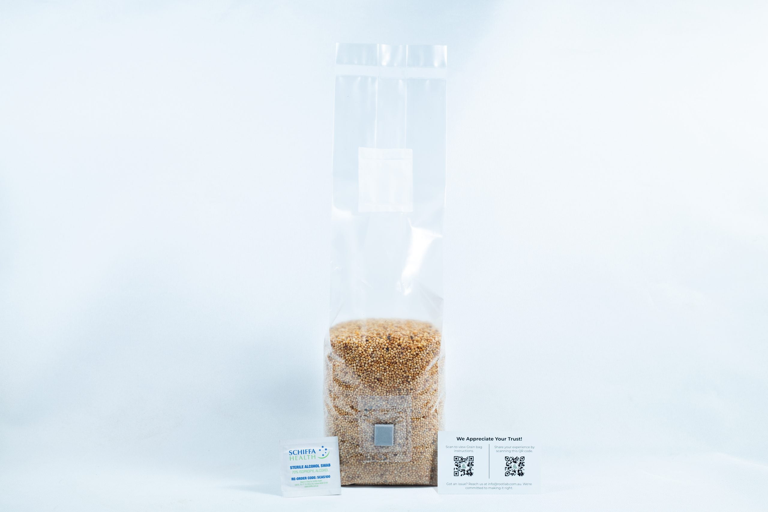 Millet pre sterilized mushroom grains w/inj port and digital instructions 2 A clear plastic bag of millet pre-sterilised mushroom grains with injection port and digital instructions is shown with two business cards on a white background.