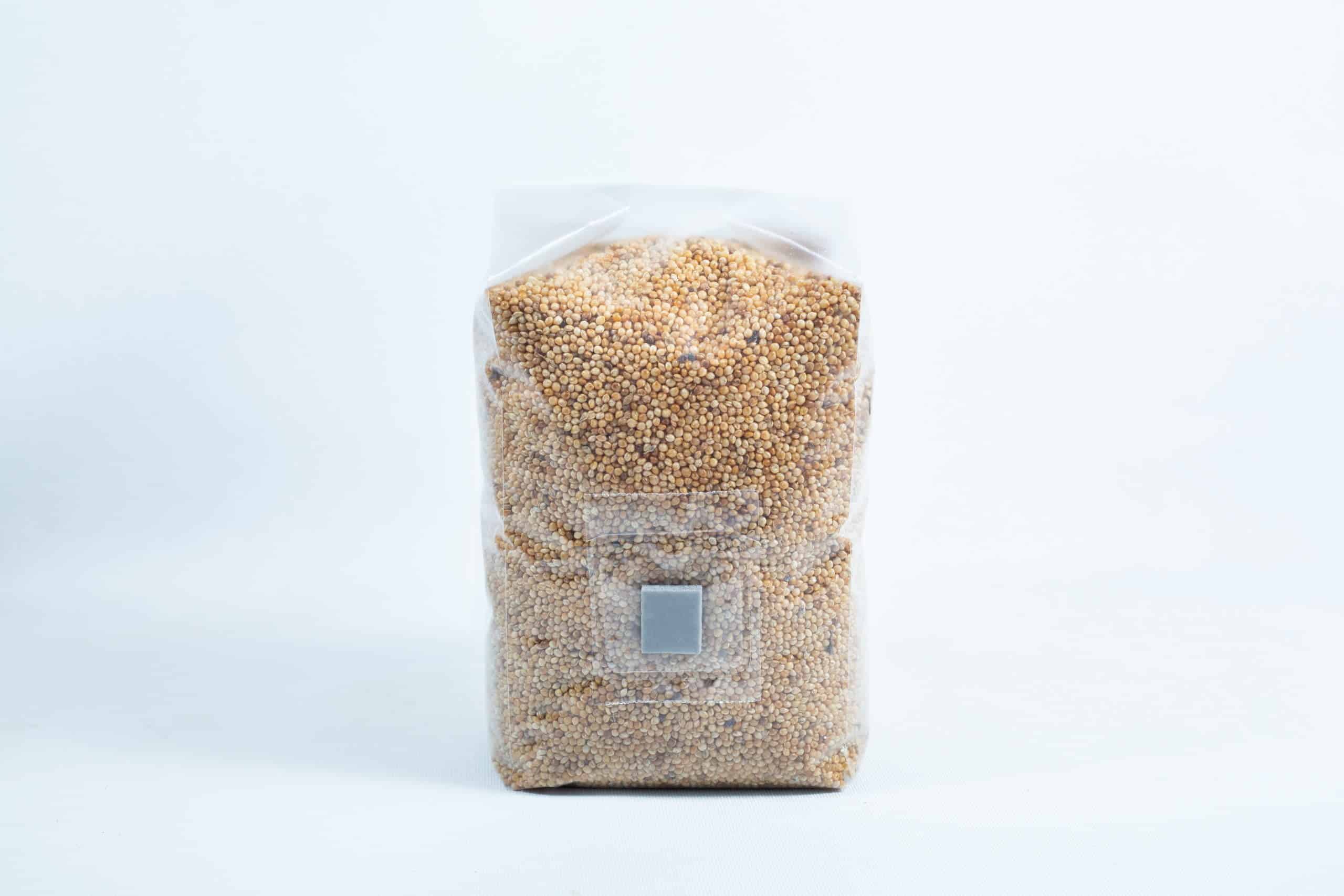 Millet pre sterilized mushroom grains w/inj port and digital instructions 4 A clear plastic bag of Millet Pre-Sterilised Mushroom Grains with injection port and digital instructions—sealed, upright on a white background, ideal for mushroom cultivation.