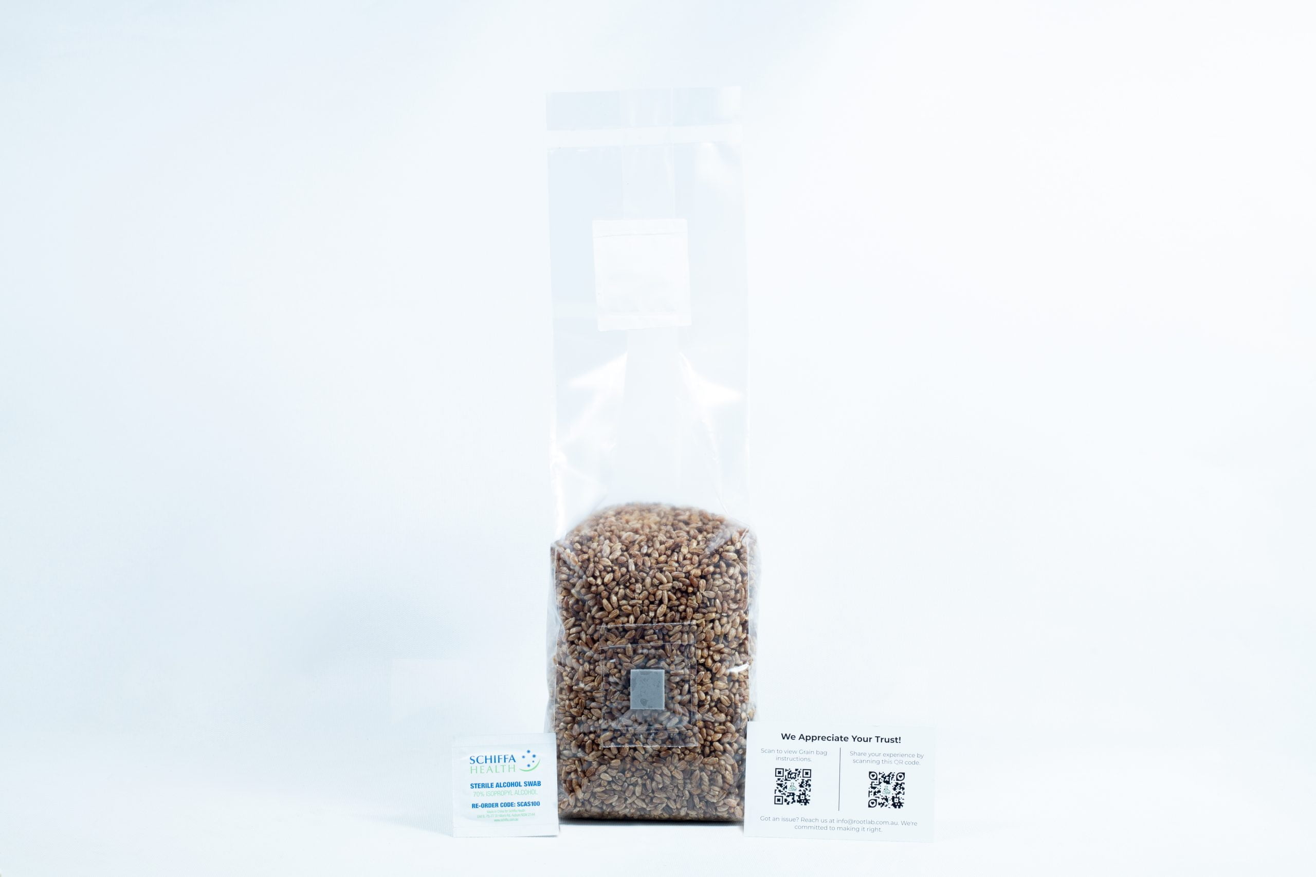 Rye grain organic Pre sterilized for mushroom cultivation w/inj port and air-filter 3 A clear bag of organic pre-sterilised rye grain for mushroom cultivation with injection port and air filter, plus two business cards in front—all on a white background.